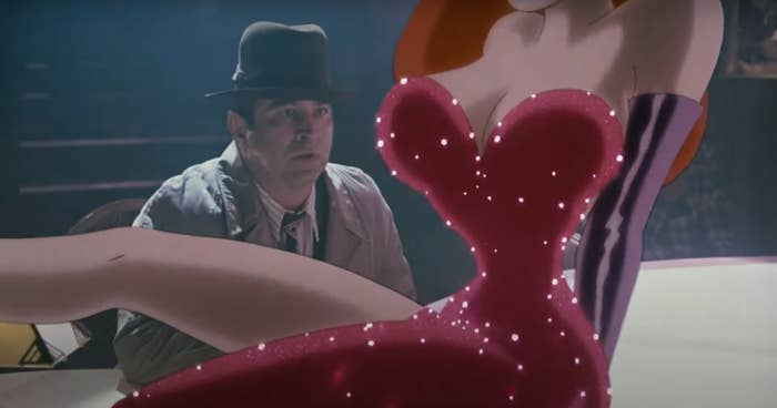 Eddie Valiant appears surprised near Jessica Rabbit in her sparkly dress, showcasing her glamorous and animated appearance