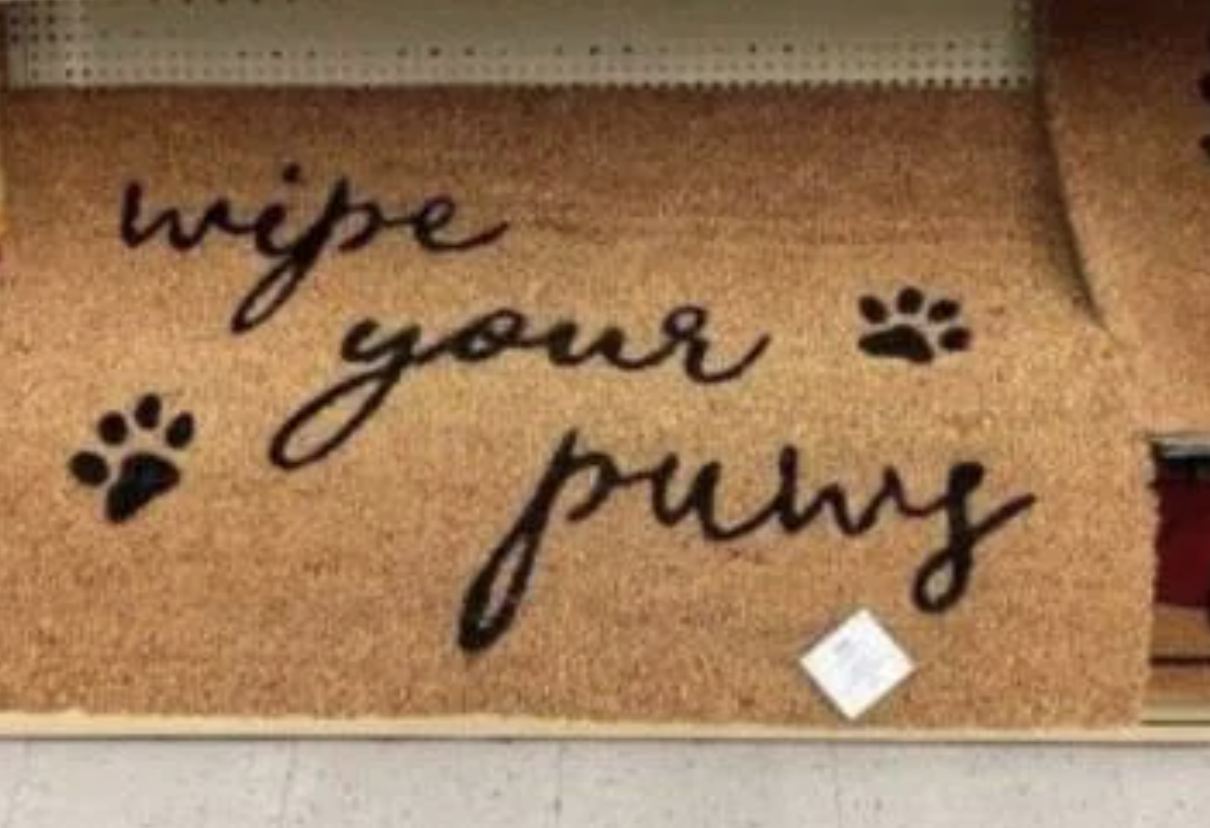 Doormat with the text "Wipe your paws" and two black paw prints