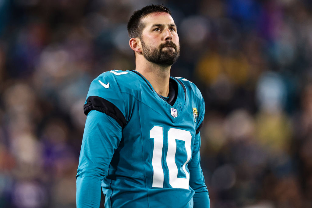 Brandon McManus with a number 10 on his jersey stands on the field, looking up