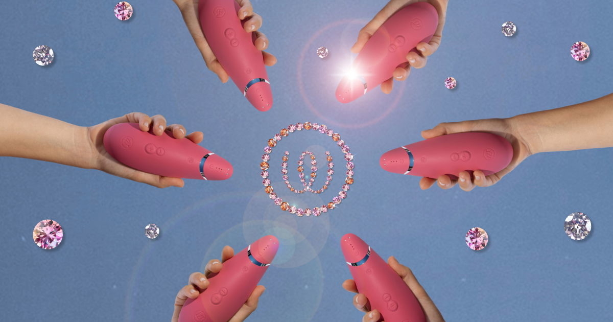 Several hands holding pink vibrators form a circle against a blue background, with sparkly gemstones and glowing circles in the center