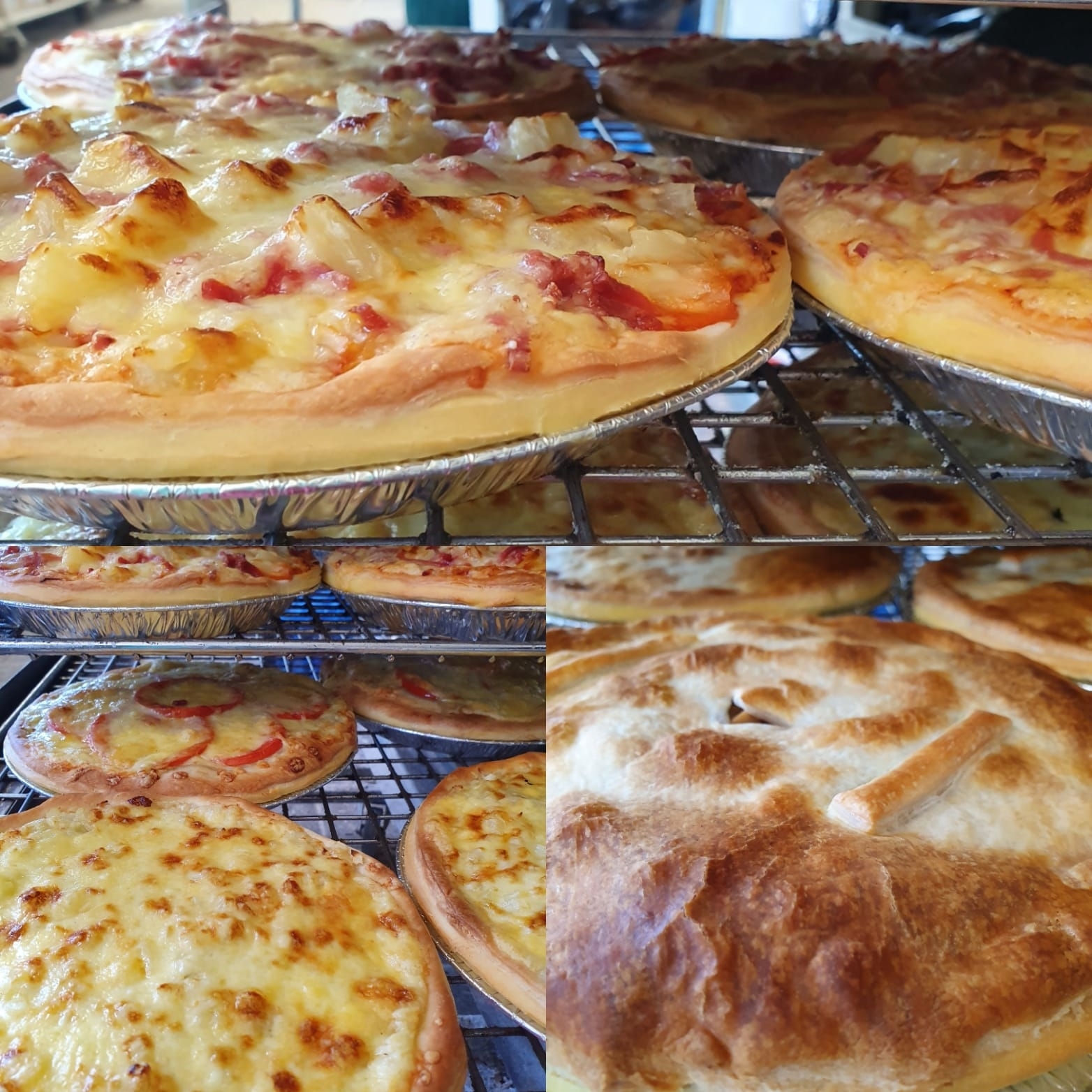 Various freshly baked pizzas and a golden-brown pie cooling on metal racks. The pizzas are topped with cheese, tomatoes, and pineapple