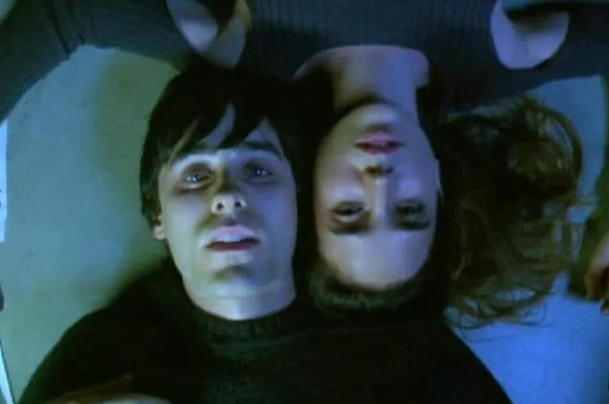 Jared Leto and Jennifer Connelly lie on the ground, heads touching, in a scene from the movie "Requiem for a Dream."