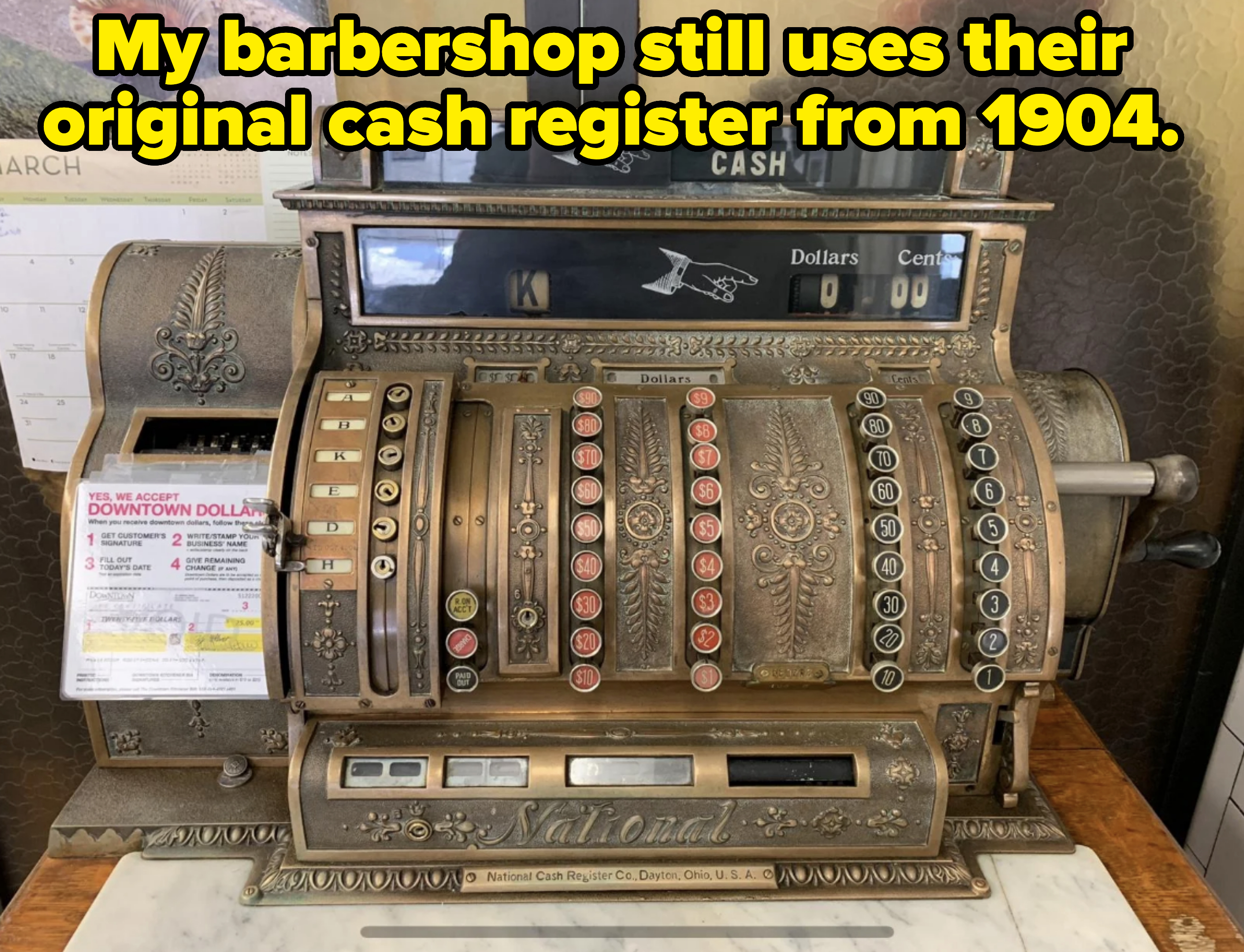 Vintage National Cash Register with ornate designs, multiple levers, and labeled buttons for dollars and cents. A small sticker on the left side shows which bills are accepted