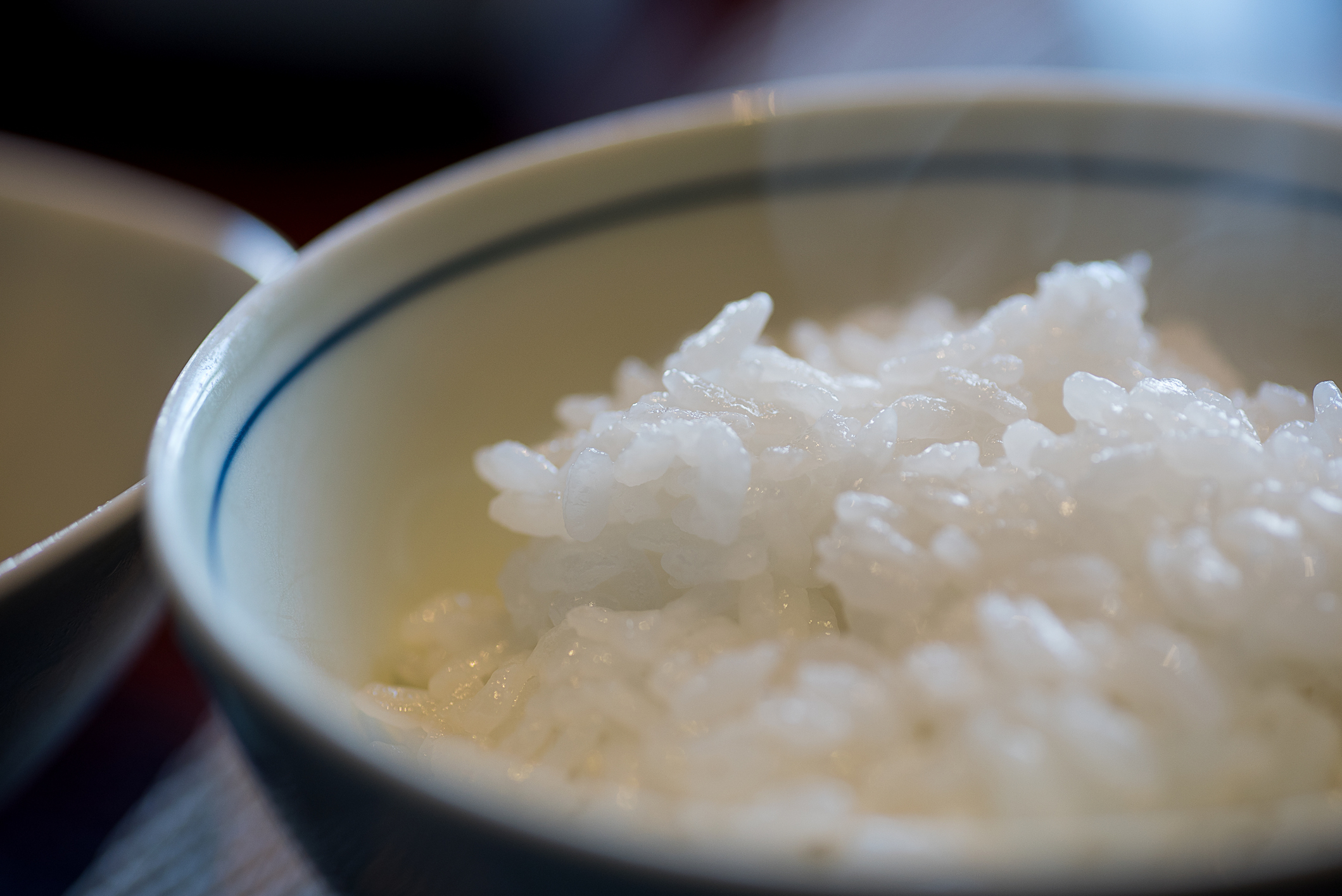 A close-up of a bowl of cooked white rice, ready to be served