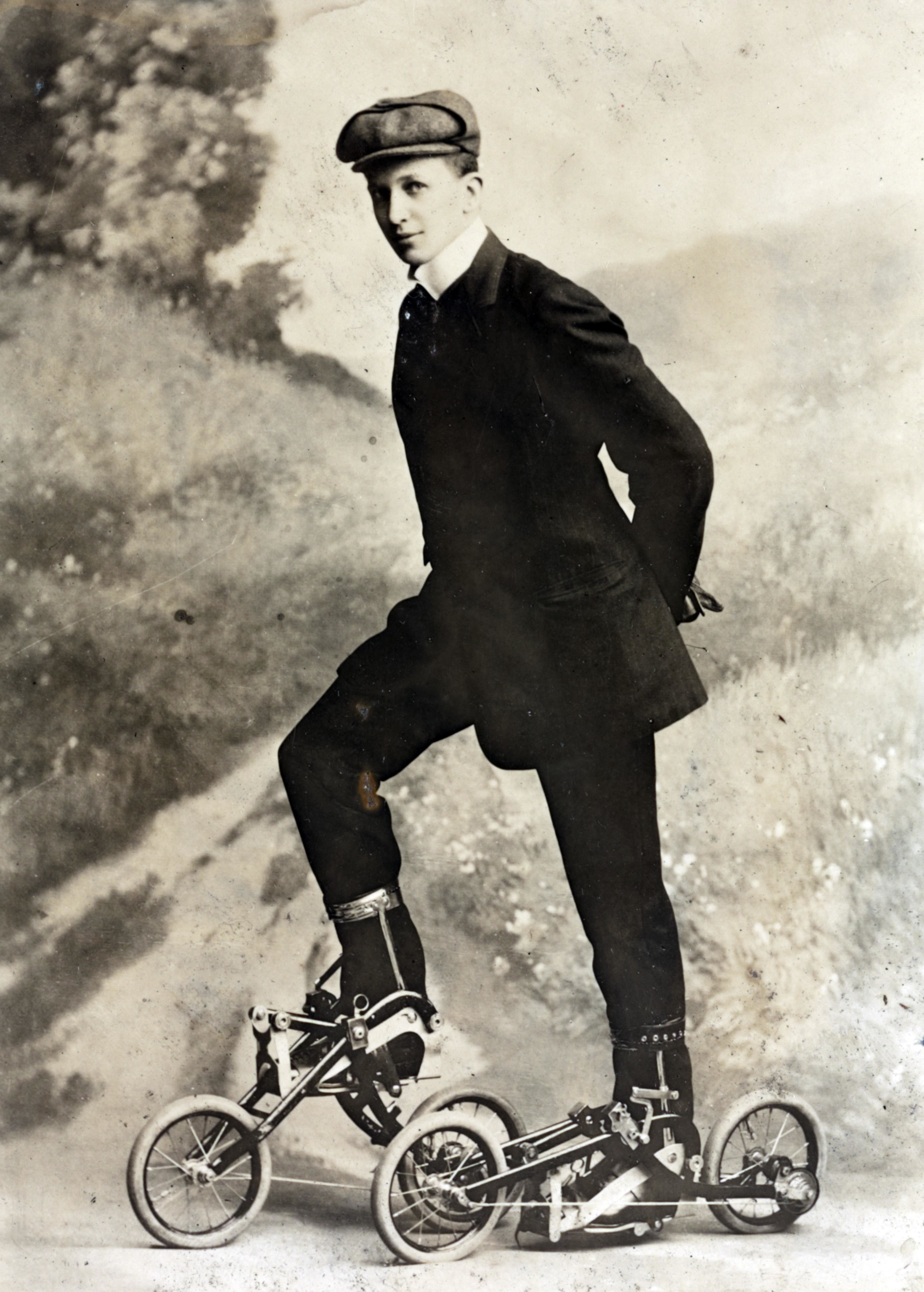 A vintage image of a person wearing early 20th-century attire and unconventional roller skates with wheels