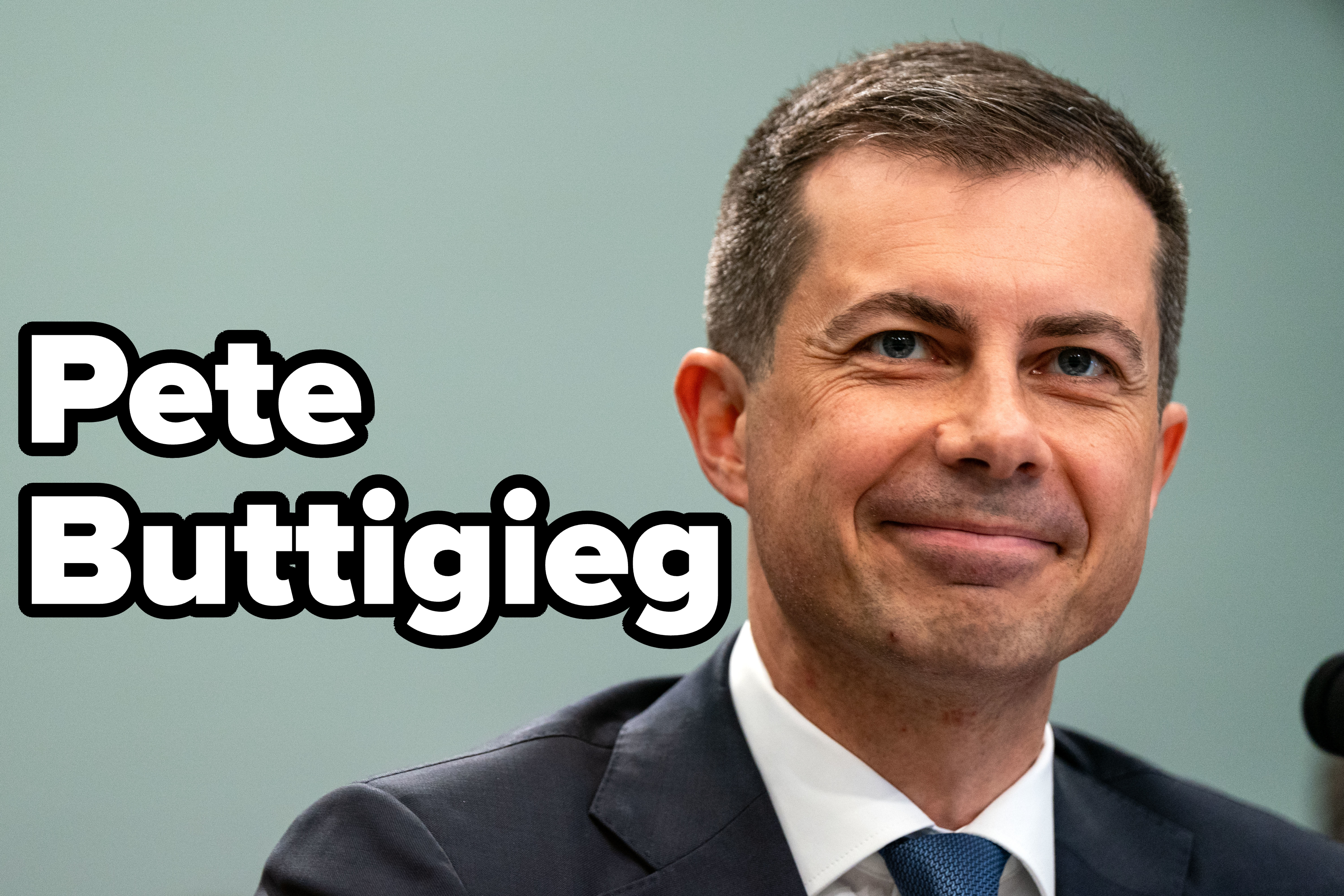 Pete Buttigieg, in a suit and tie, smiling while speaking at an event