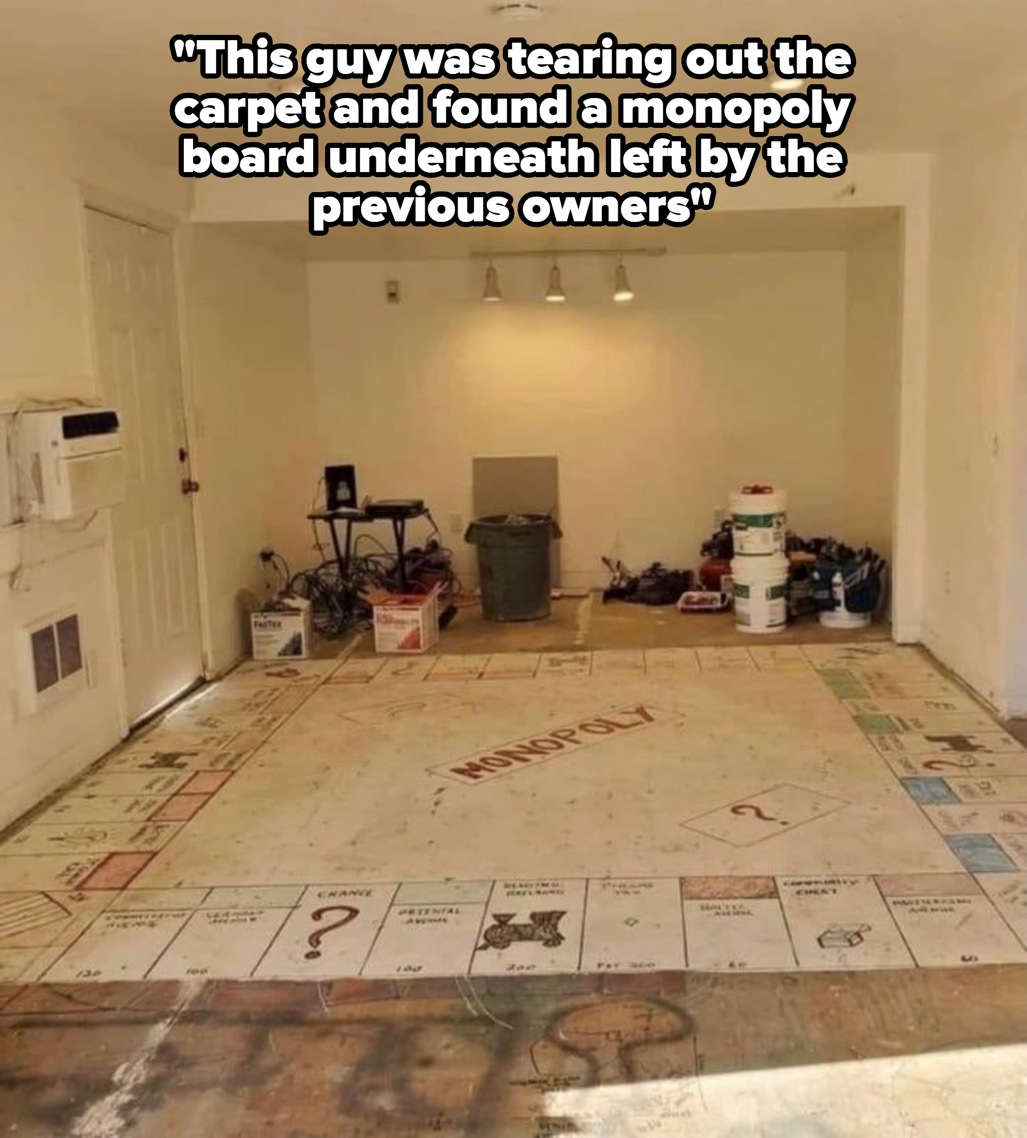Garage converted into a Monopoly-themed room. The floor resembles a Monopoly board with squares and property names, and there are various boxes and paint cans around