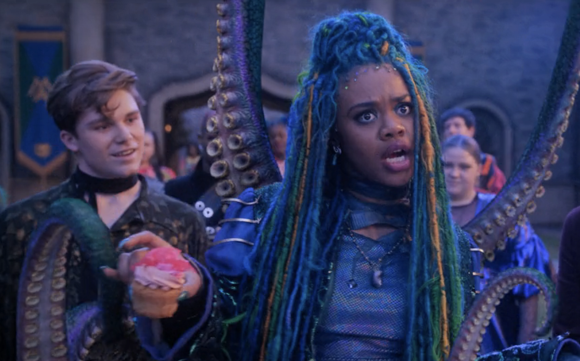 Dara as Uliana, with long, mutlicolored hair and tentacles, holding a cupcake