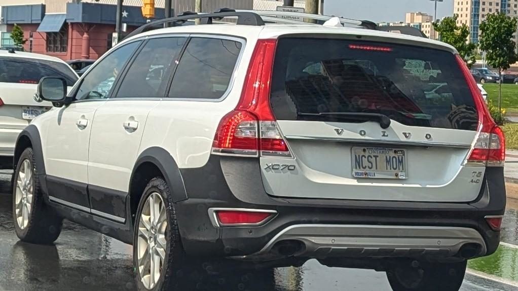 A Volvo XC70 with a personalized license plate that reads &quot;NCST MOW&quot; is seen in a busy parking lot