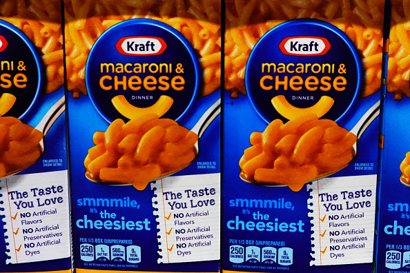 Kraft Macaroni & Cheese Dinner boxes showing the product name, tagline "smmmile, it's the cheesiest," and promotion of no artificial flavors, preservatives, or dyes
