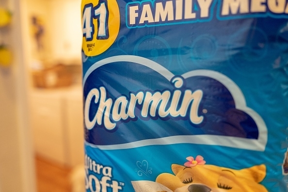 Close-up of Charmin toilet paper packaging displaying the brand name and family-sized pack suitable for 41 regular rolls, featuring a cartoon bear