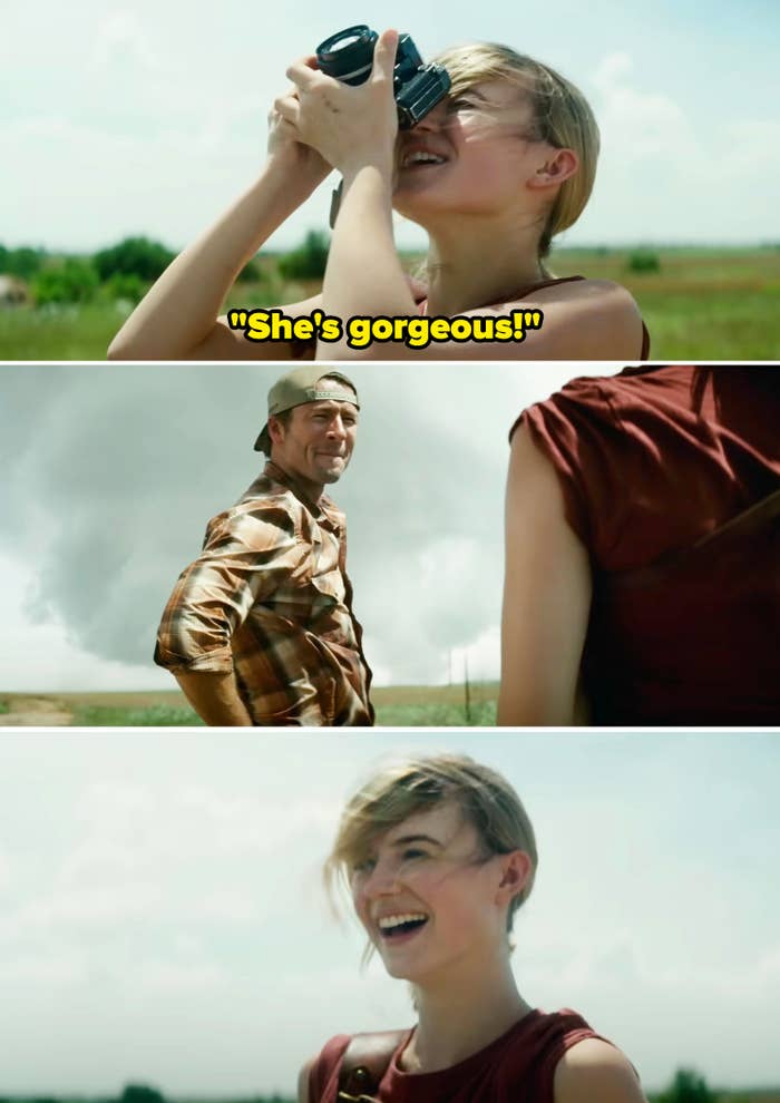 Kate taking a picture of a tornado as Tyler smiles at her