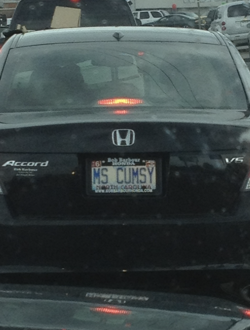 A Honda Accord with a North Carolina license plate reads "MS CUMSY" while waiting in traffic