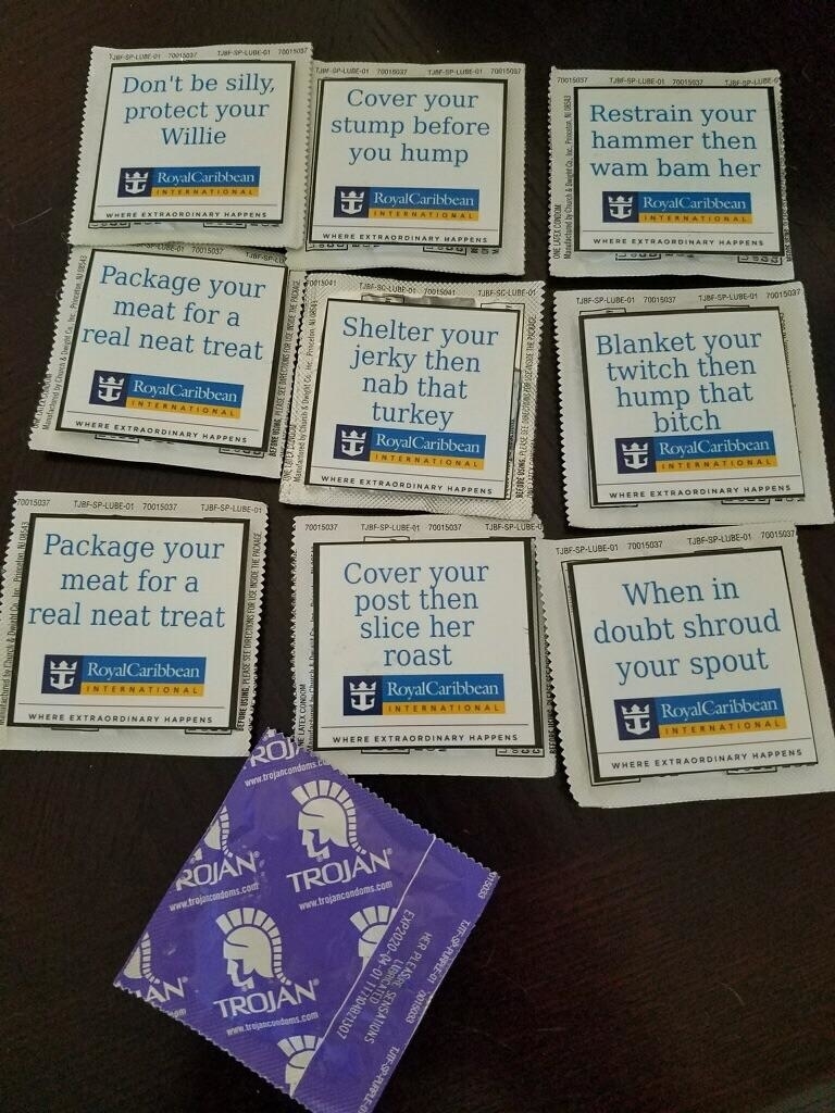 Ten Royal Caribbean napkins with humorous messages about practicing safe sex, and one purple Trojan condom package in the center