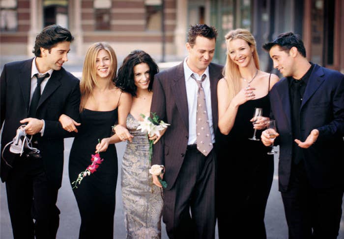 David Schwimmer, Jennifer Aniston, Courteney Cox, Matthew Perry, Lisa Kudrow, and Matt LeBlanc from Friends, smiling and walking together on a street