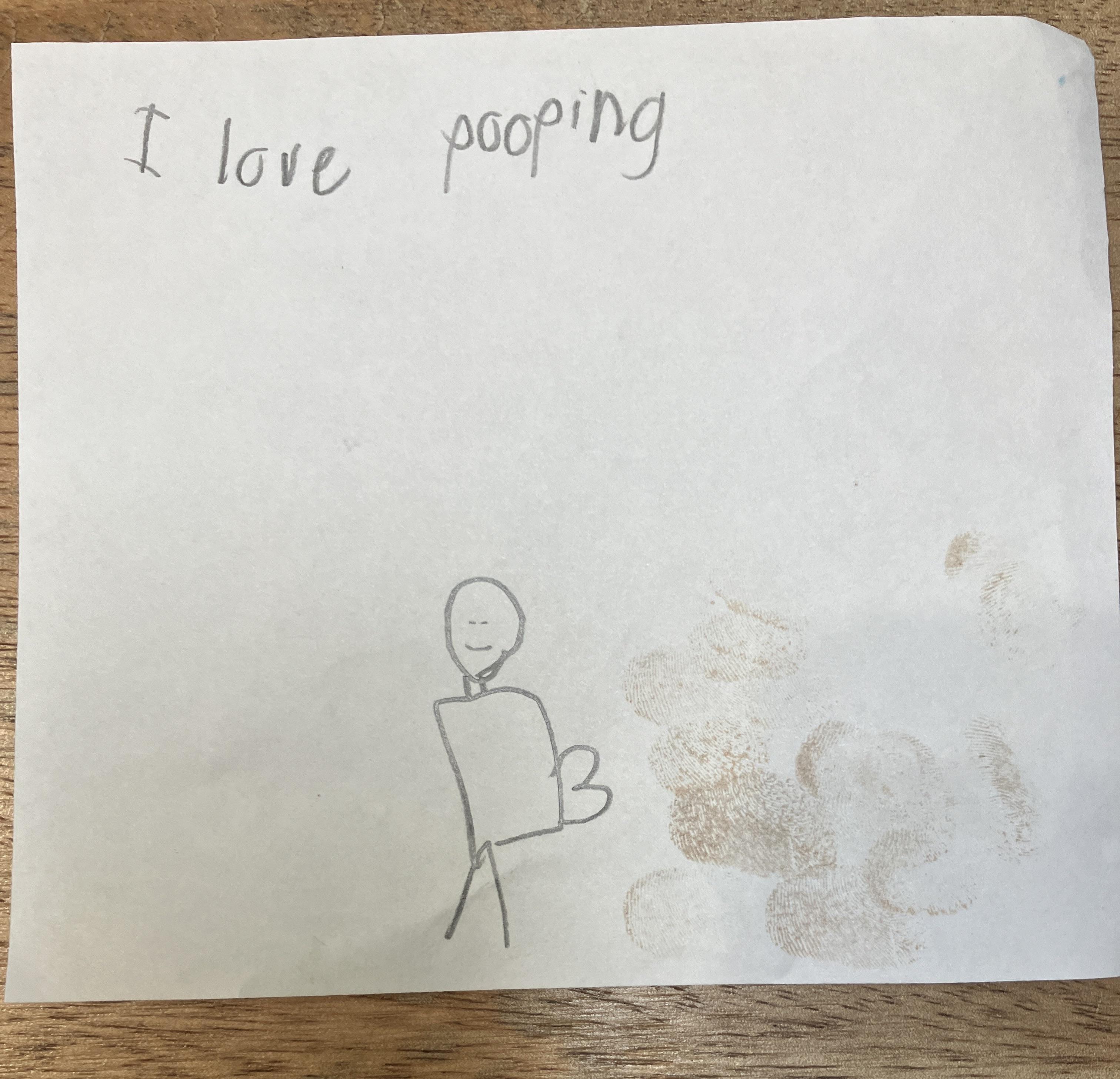 A child's drawing with the text "I love pooping" and a stick figure next to a pile