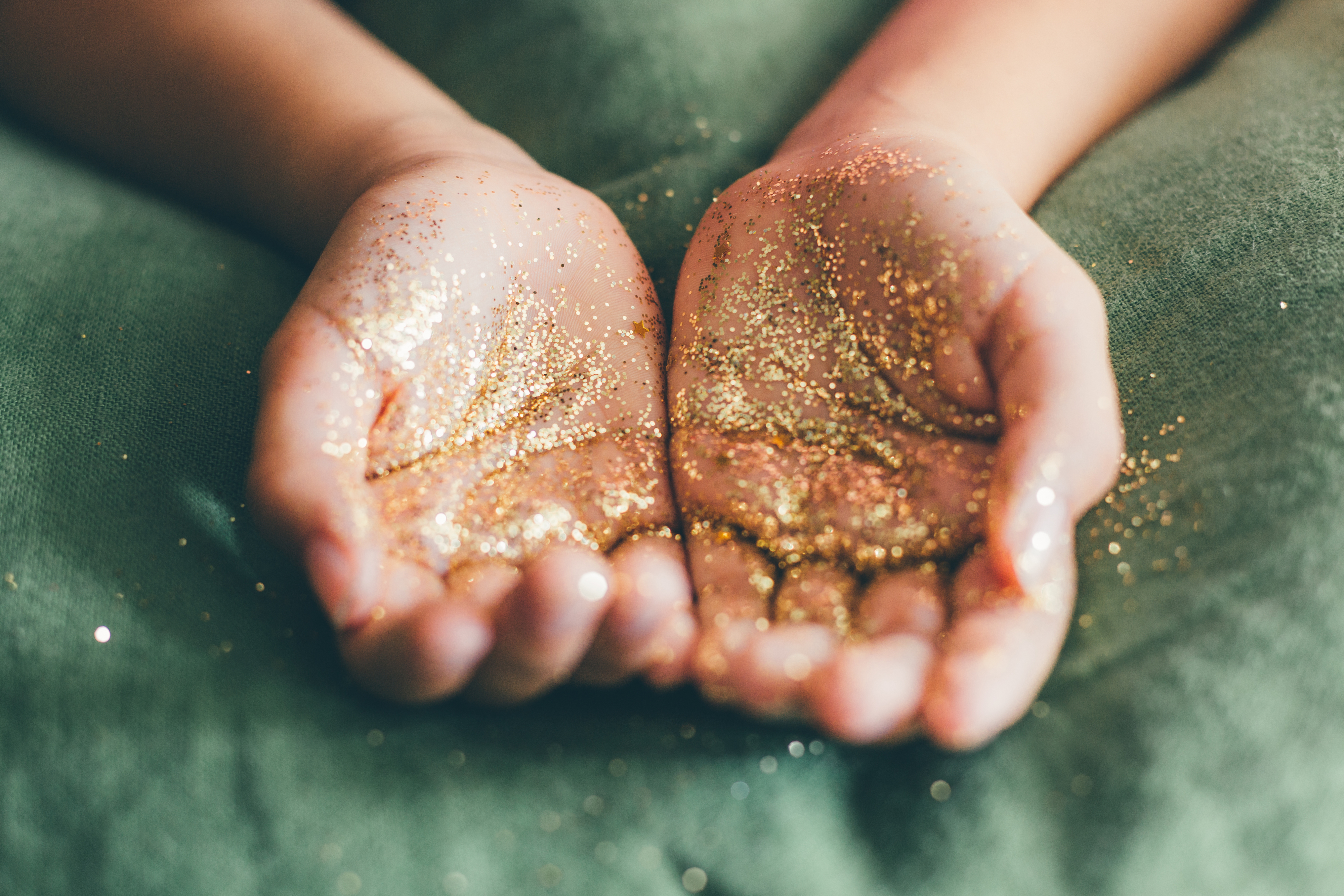 Pair of hands holding glitter