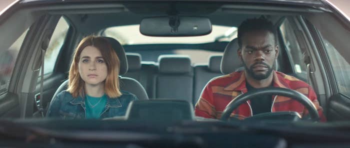 Aya Cash and William Jackson Harper sit in a car with tense expressions on their faces in a scene from &quot;We Broke Up&quot;