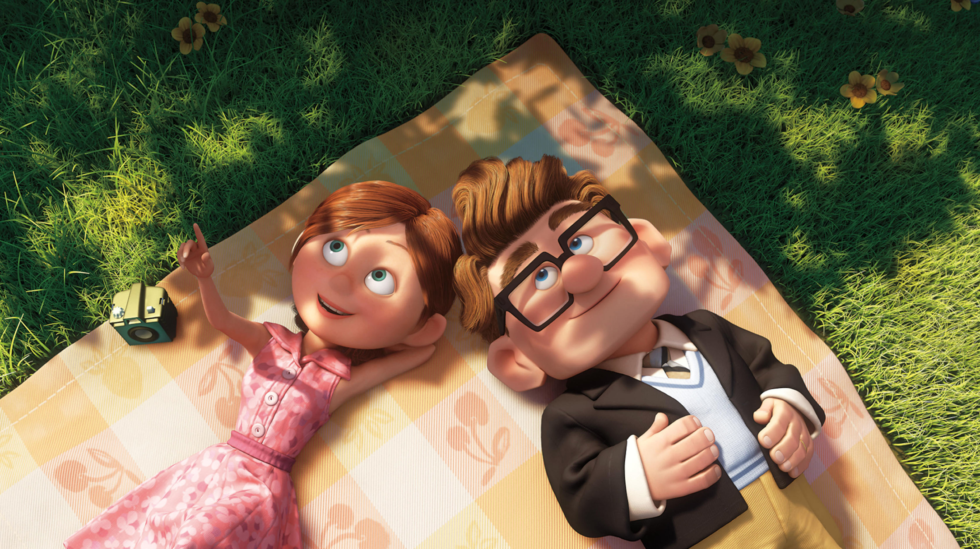 Animated characters Ellie and Carl Fredricksen from &quot;Up&quot; are lying on a picnic blanket, looking at the sky. Ellie is in a pink dress, and Carl wears a suit