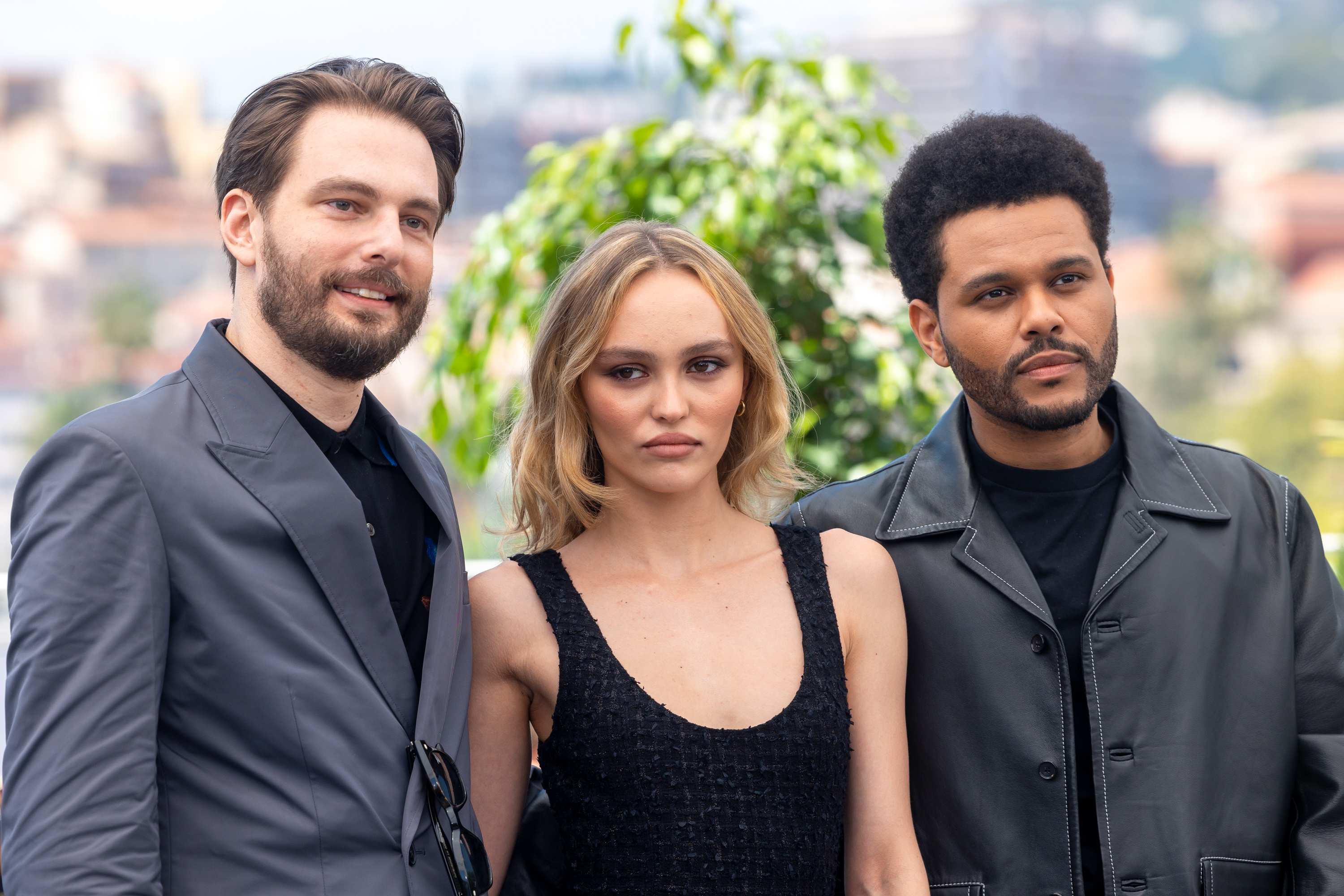 Sam Levinson, Lily-Rose Depp, and The Weeknd pose together at an event
