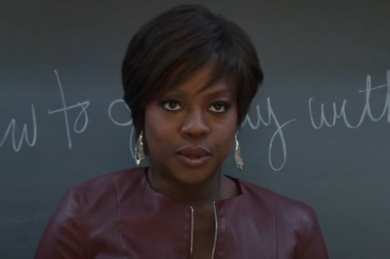 Viola Davis stands in front of a blackboard with cursive writing as Annalise Keating in How to Get Away With Murder