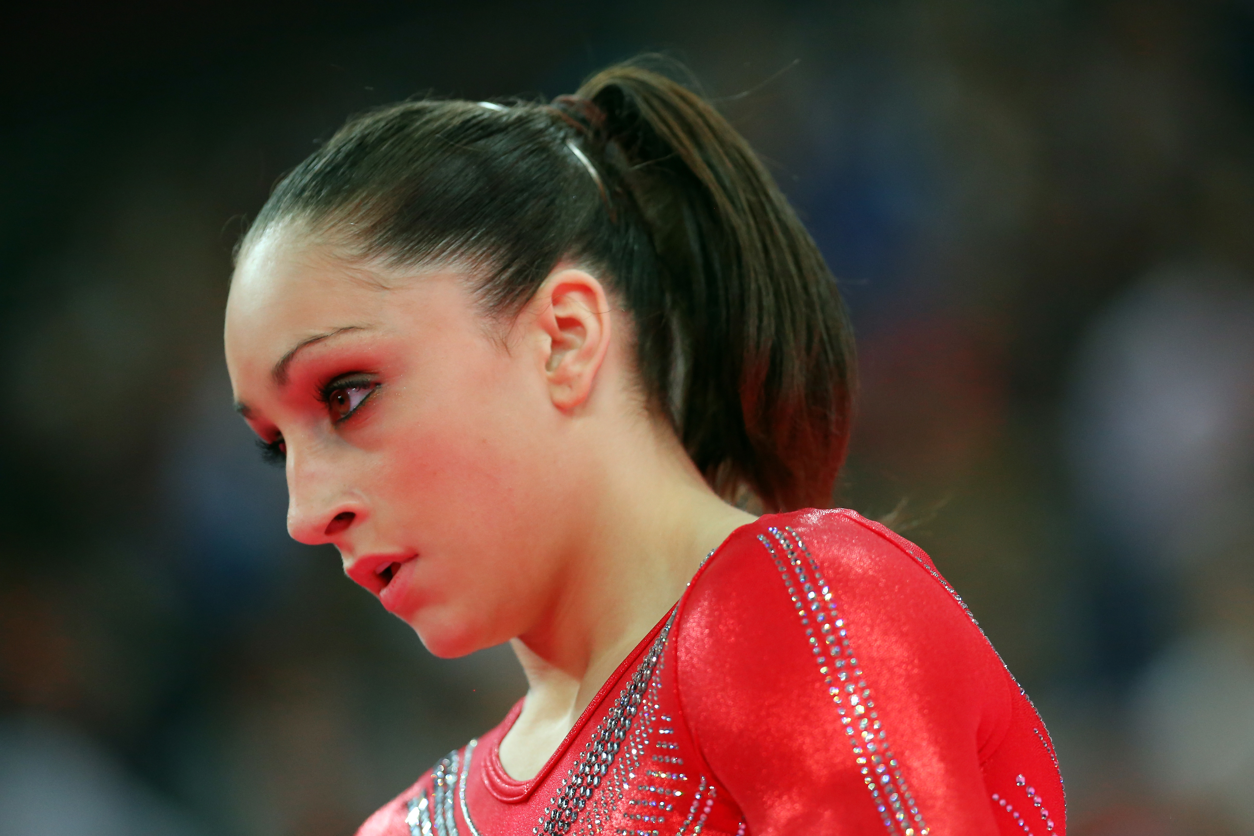 Gymnast Jordyn Wieber wearing a sparkling leotard, gazing to the side during a performance