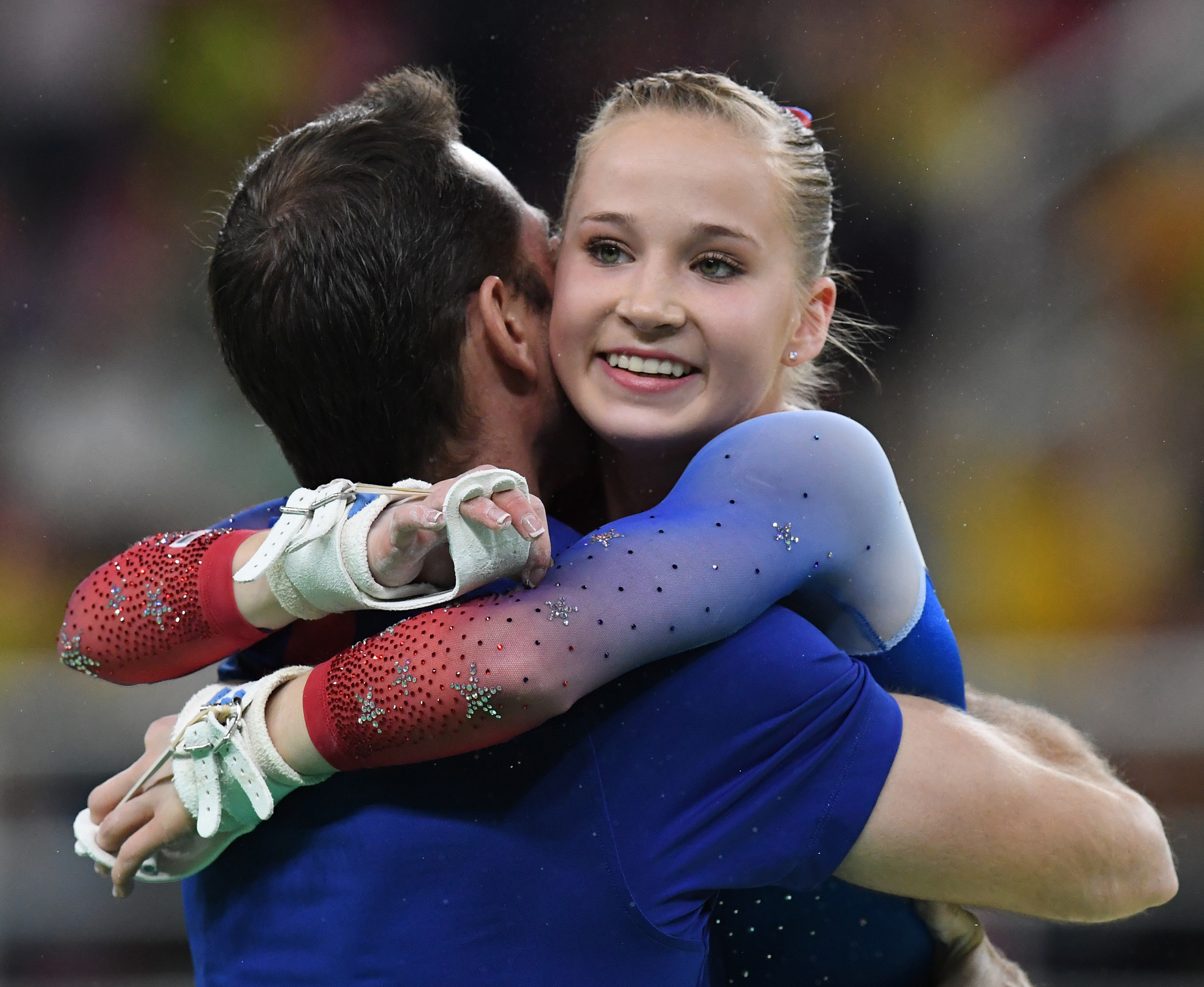 Gymnast hugging a coach