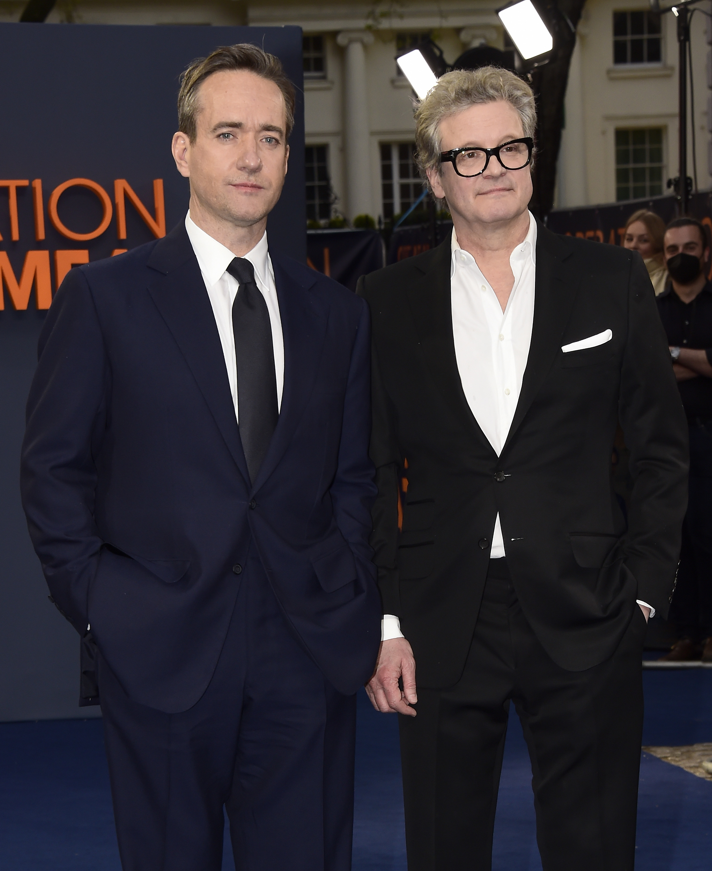 Matthew Macfadyen and Colin Firth stand together in suits at a formal event, posing for photos