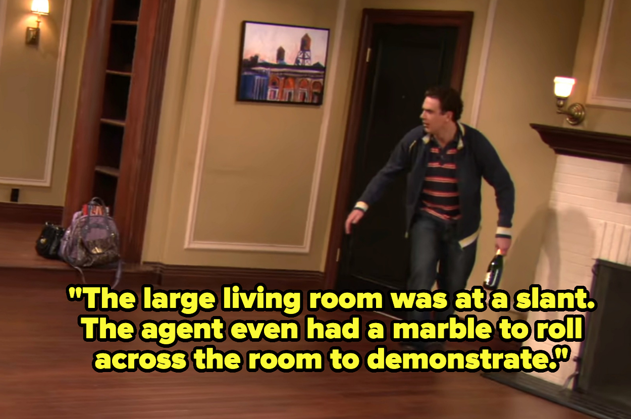 Marshall from HIMYM in casual clothing looks at a slanted living room. Wall art and bags are visible. Text: "The large living room was at a slant., the agent even had a marble to roll across the room to demonstrate"