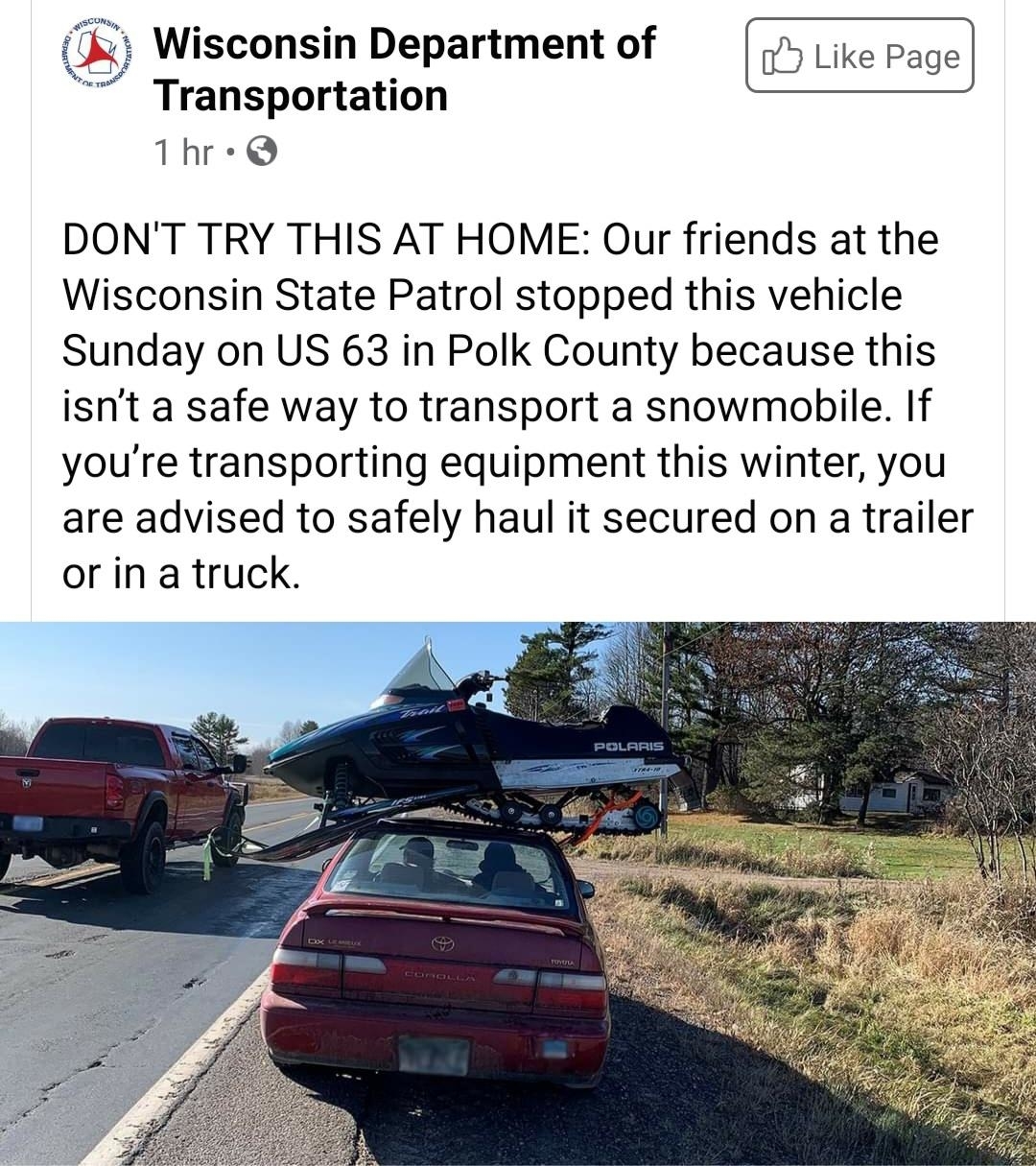 A car with a snowmobile precariously placed on its roof is shown. Text from the Wisconsin Department of Transportation advises against this unsafe transport method
