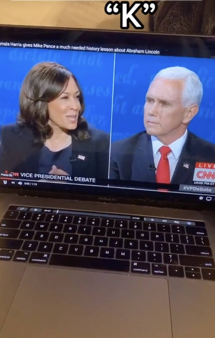 Kamala Harris and Mike Pence during the vice presidential debate shown on a laptop screen. The text on the screen mentions Kamala Harris giving a history lesson about Abraham Lincoln