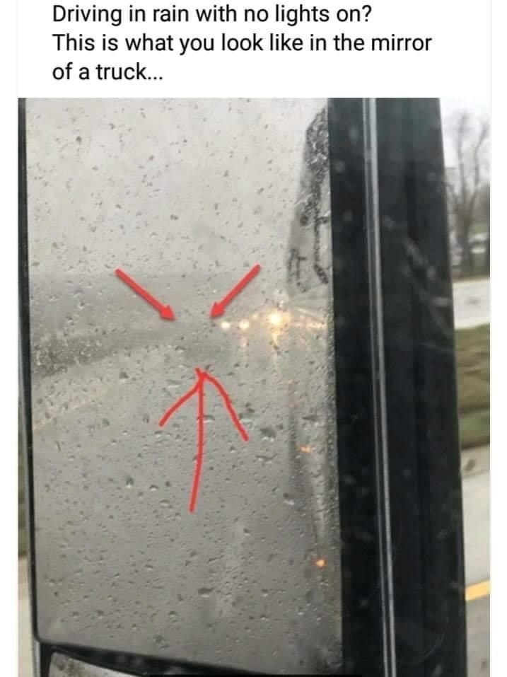 Truck side mirror in rain reflects faint vehicle lights without headlights, highlighted by overlaid red arrows and an angry face drawing. Text warns about driving hazards
