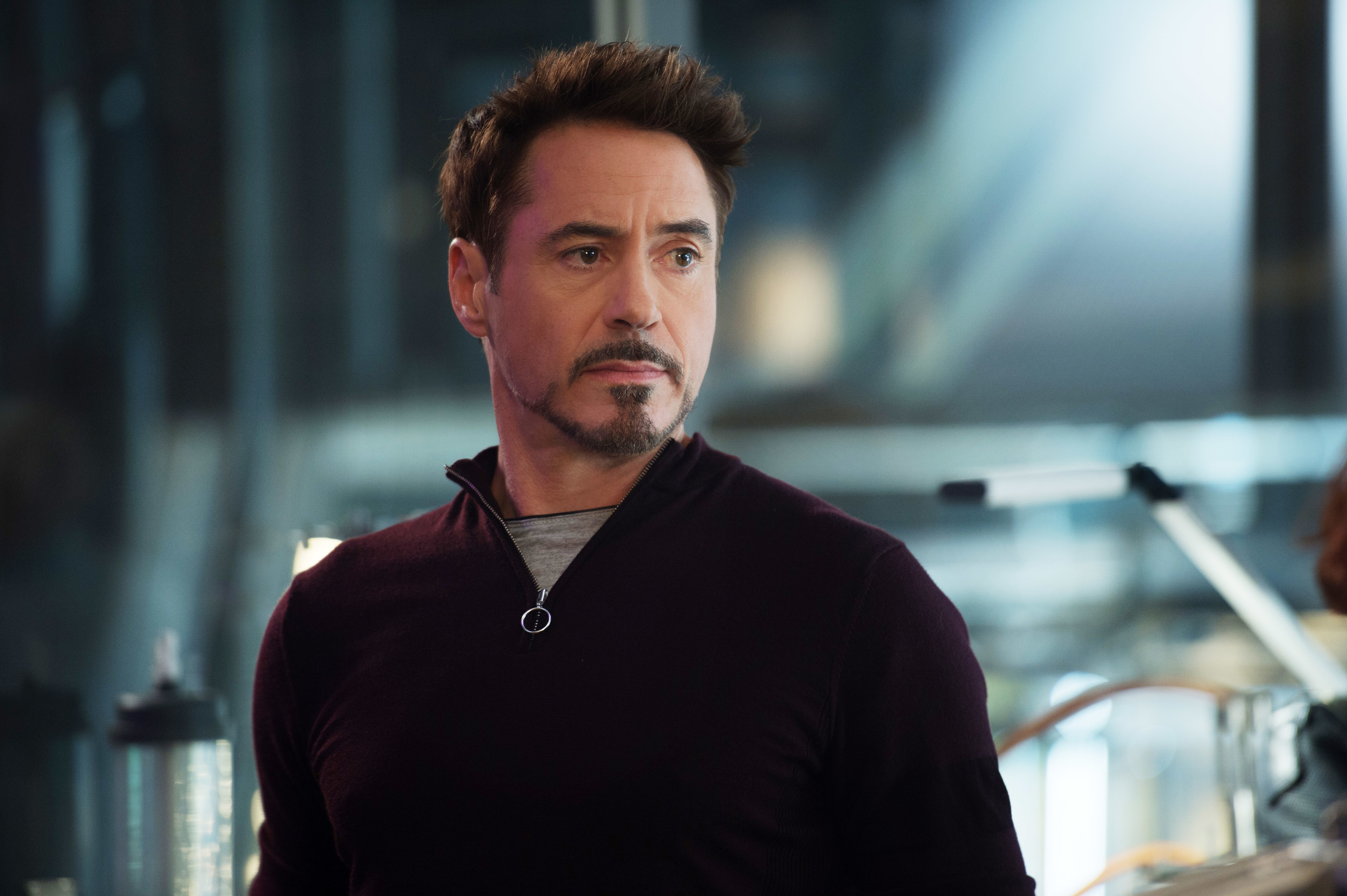 Robert Downey Jr. in a casual outfit with a visible backdrop of tech equipment