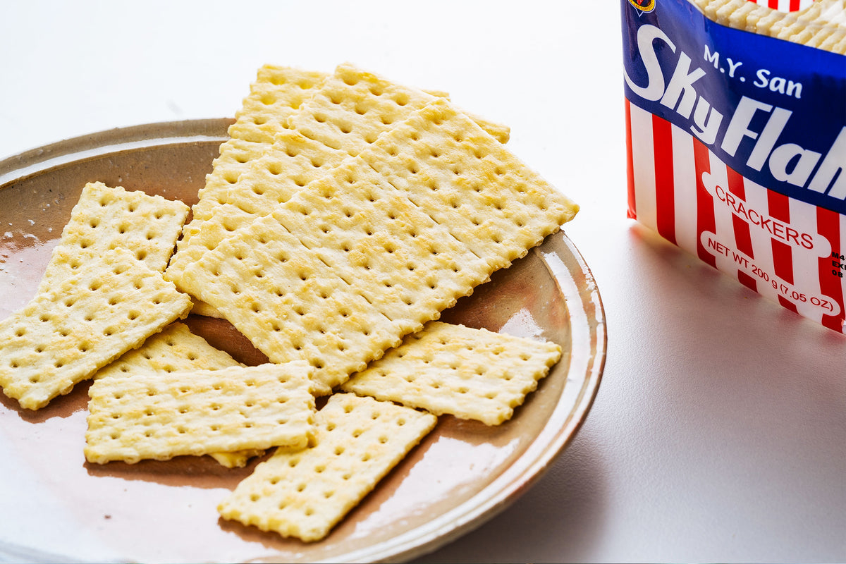 SkyFlakes crackers are spread out on a plate next to an open SkyFlakes cracker box