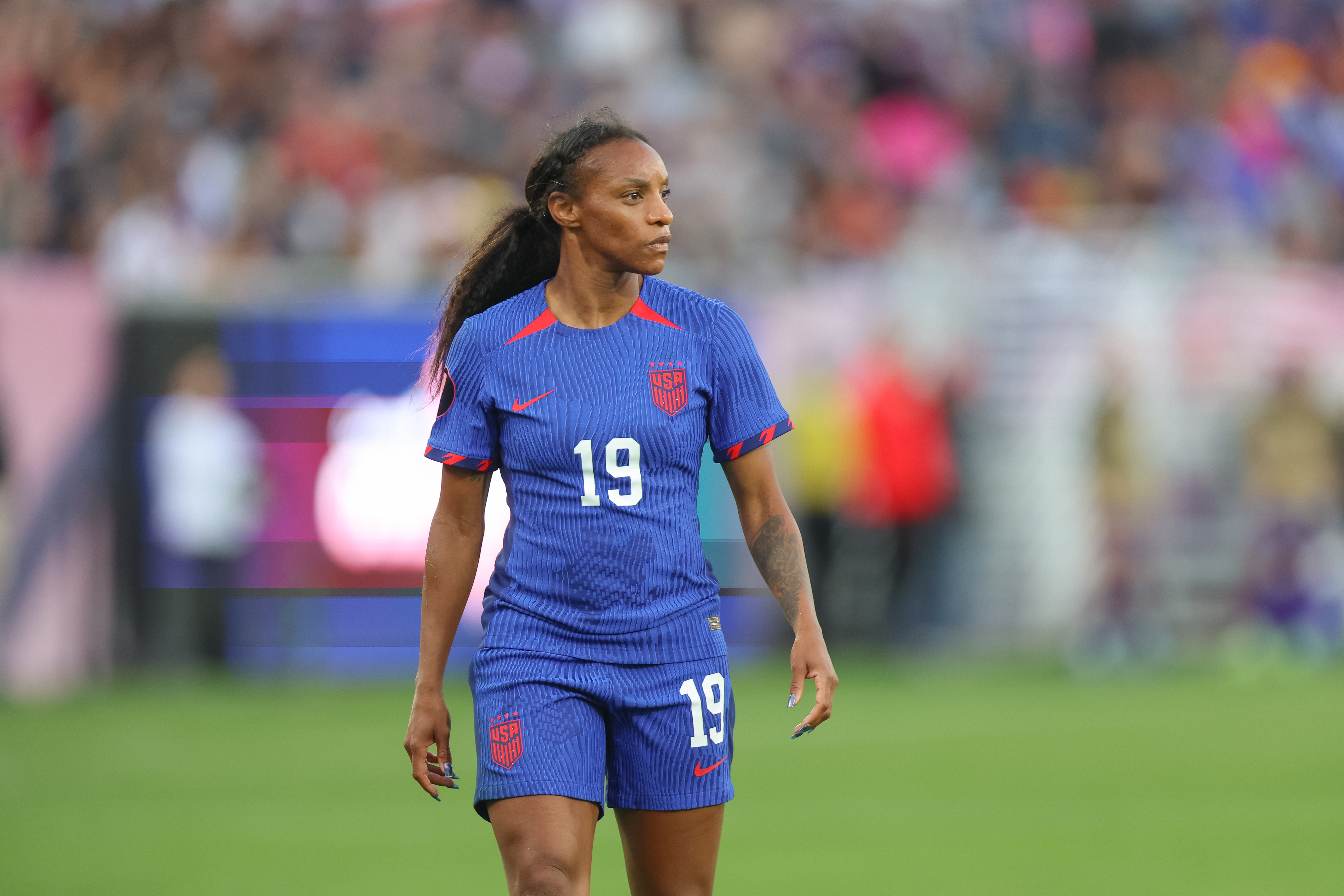 Crystal Dunn on a soccer field wearing a jersey with the number 19 during a match