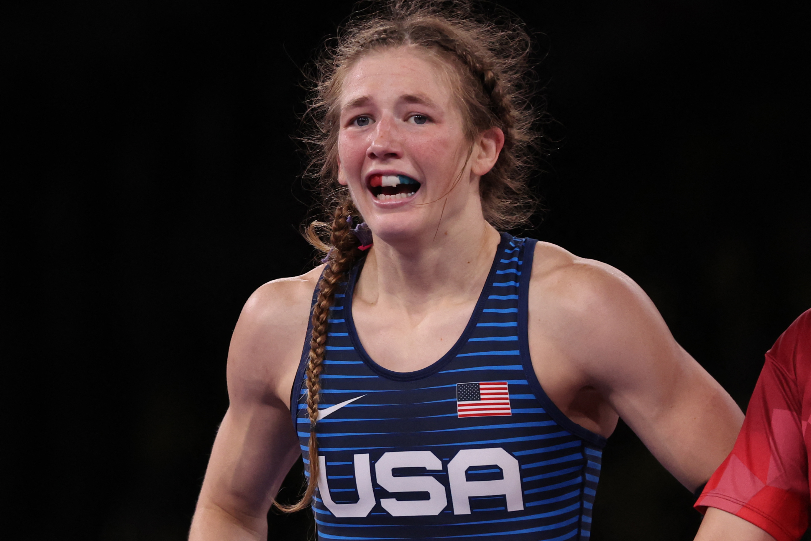 Sarah Hildebrandt  wearing a USA singlet, looking emotional on the mat during a competition
