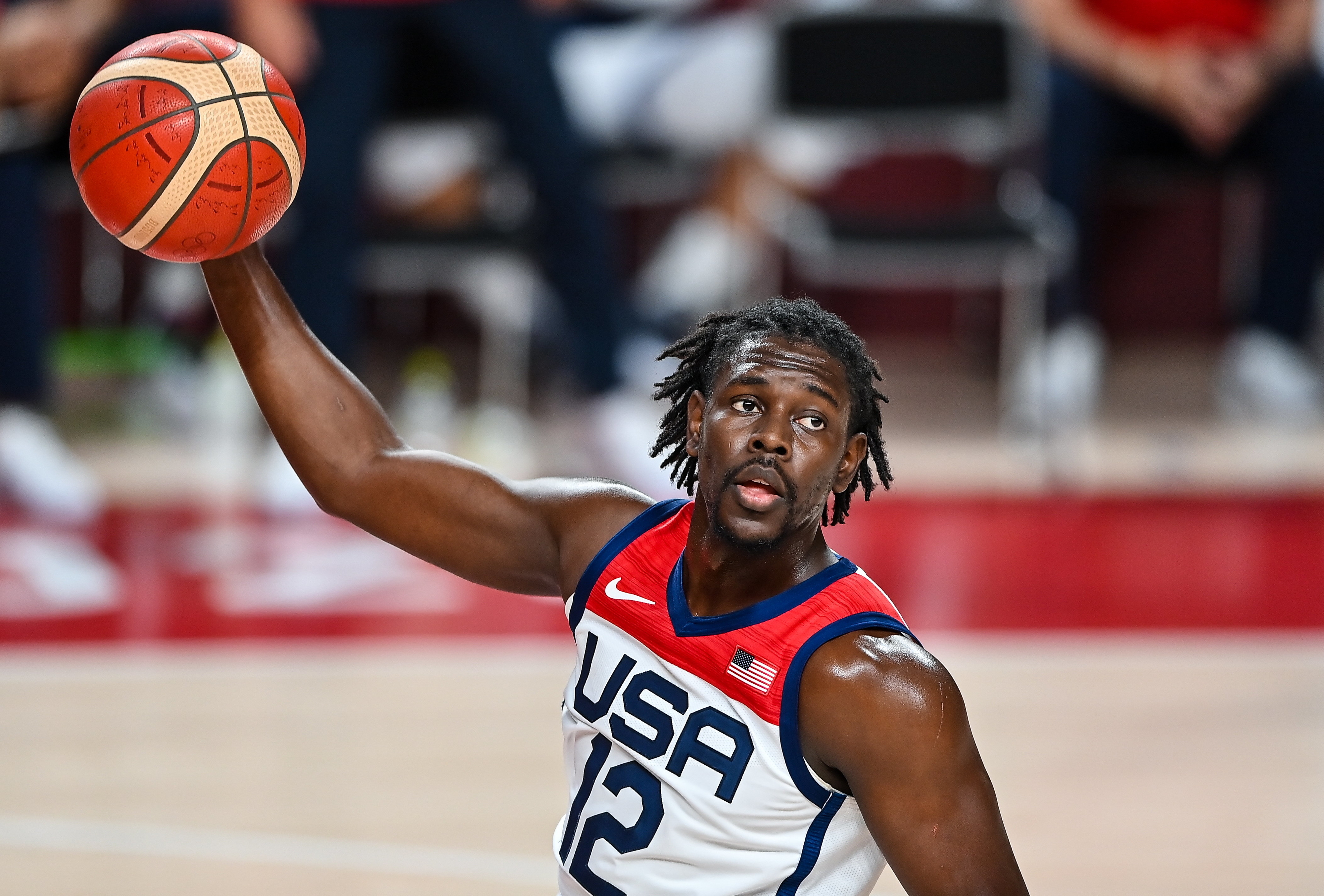 Jrue Holiday of Team USA holds a basketball, preparing to shoot a layup during a game