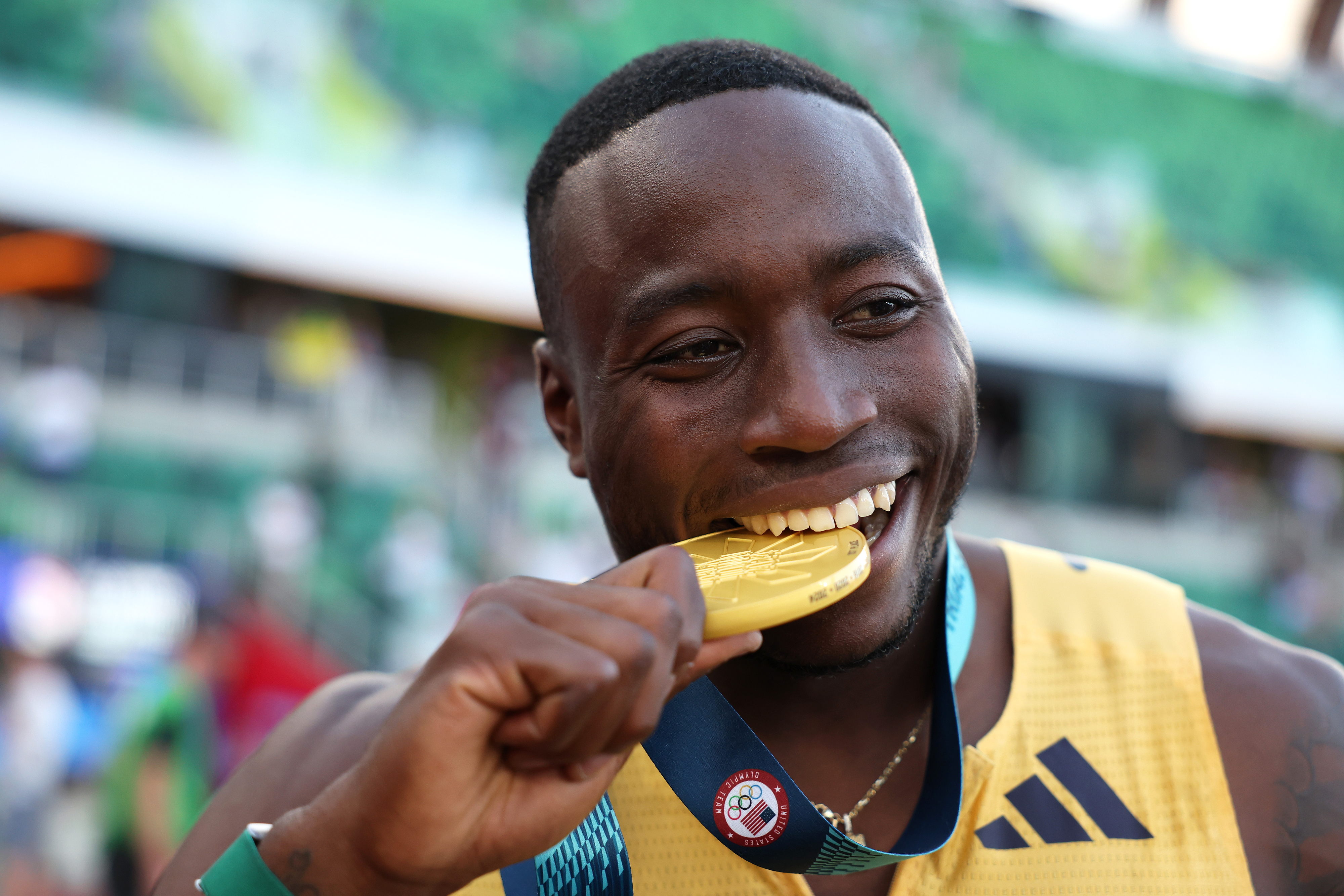 Athlete celebrating by playfully biting a gold medal