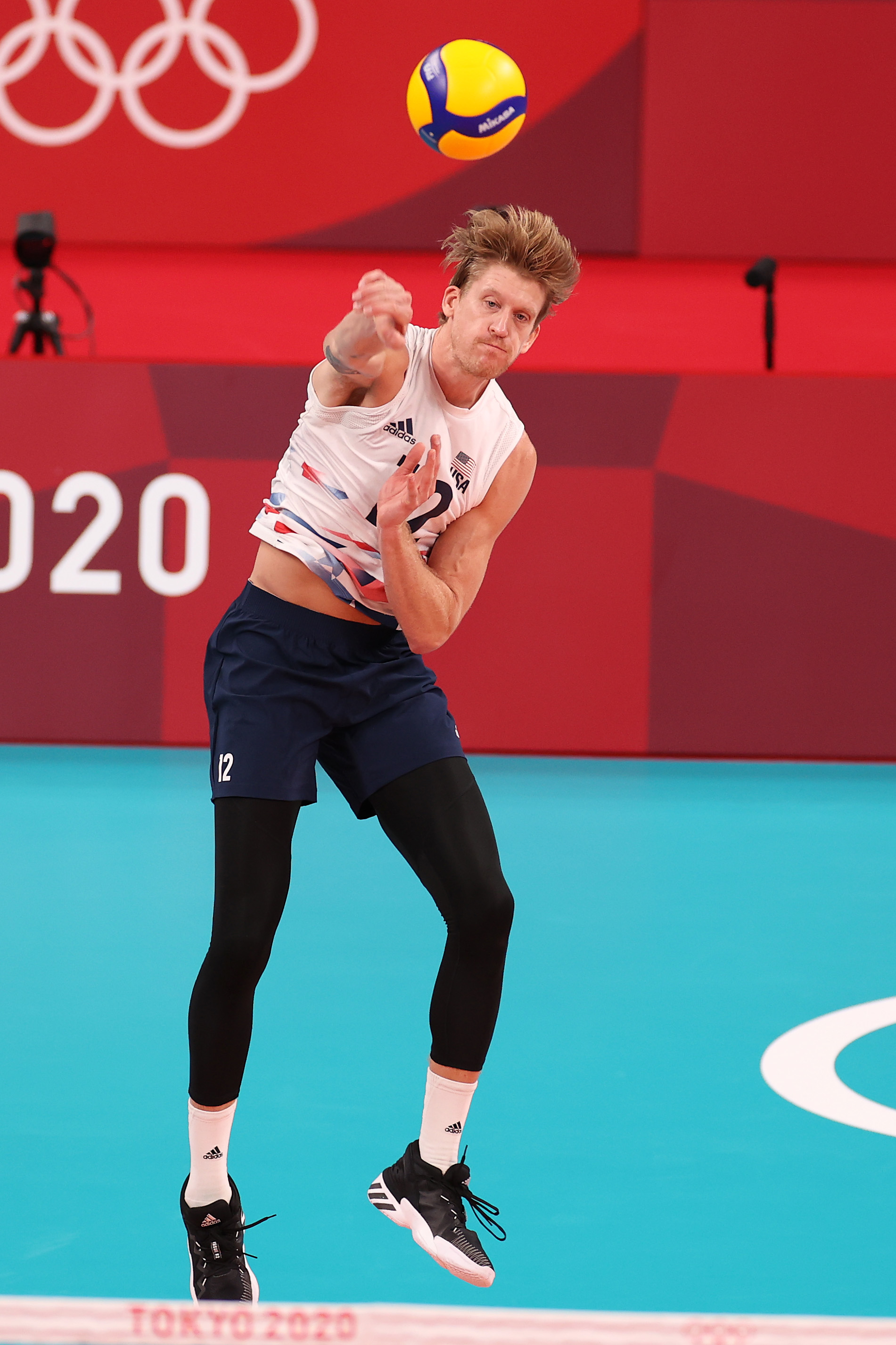 USA volleyball player holt in action at Tokyo 2020 Olympics, wearing a sleeveless top, shorts, and leggings