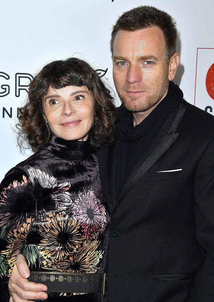 Eve Mavrakis and Ewan McGregor on the red carpet, with Eve in a floral dress and Ewan in a dark suit