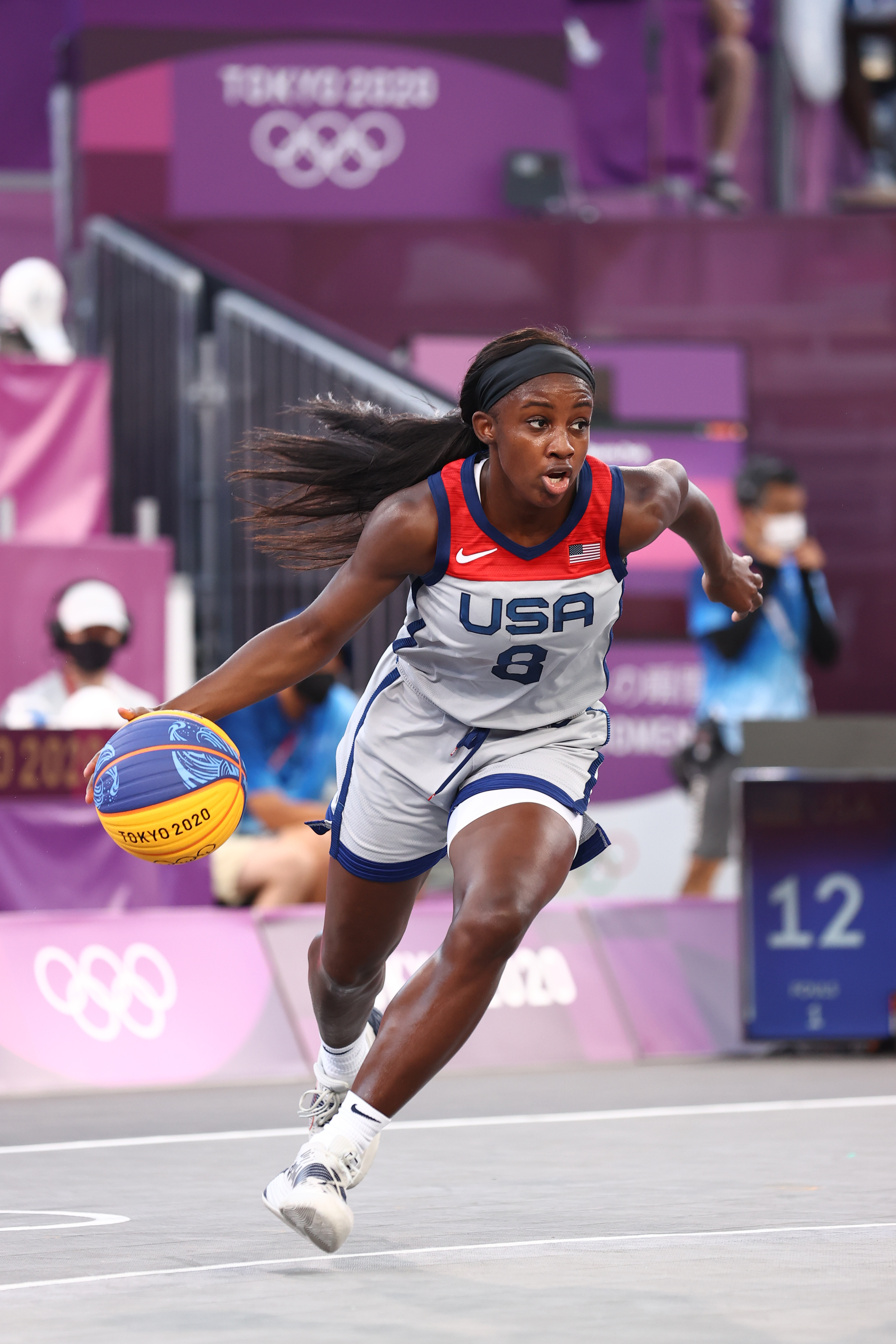 USA basketball player, Allisha Gray, wearing jersey number 8, dribbles a ball during a game at the Tokyo 2020 Olympics