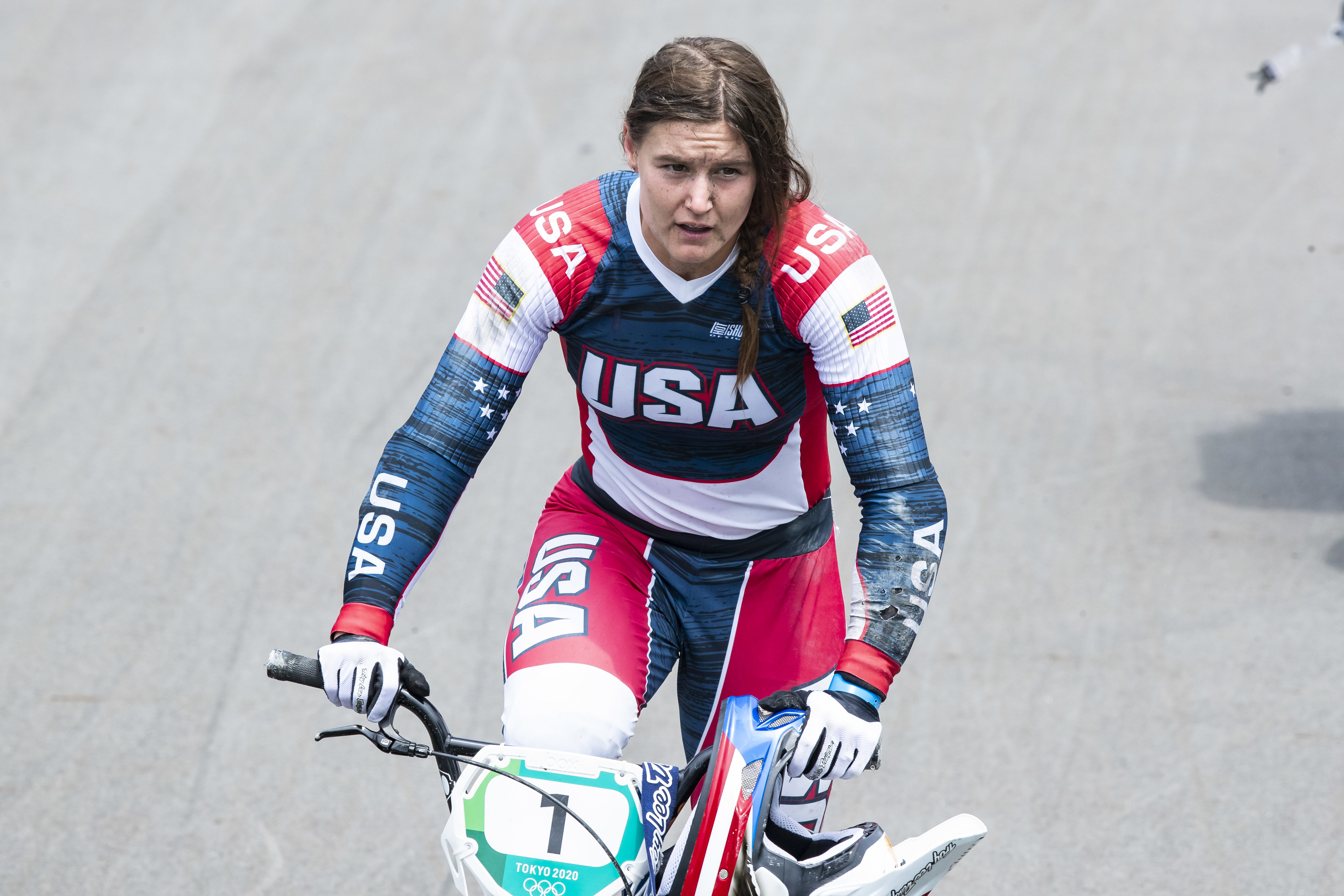 Alise Willoughby wearing USA team uniform riding on a track during the Tokyo 2020 Olympics