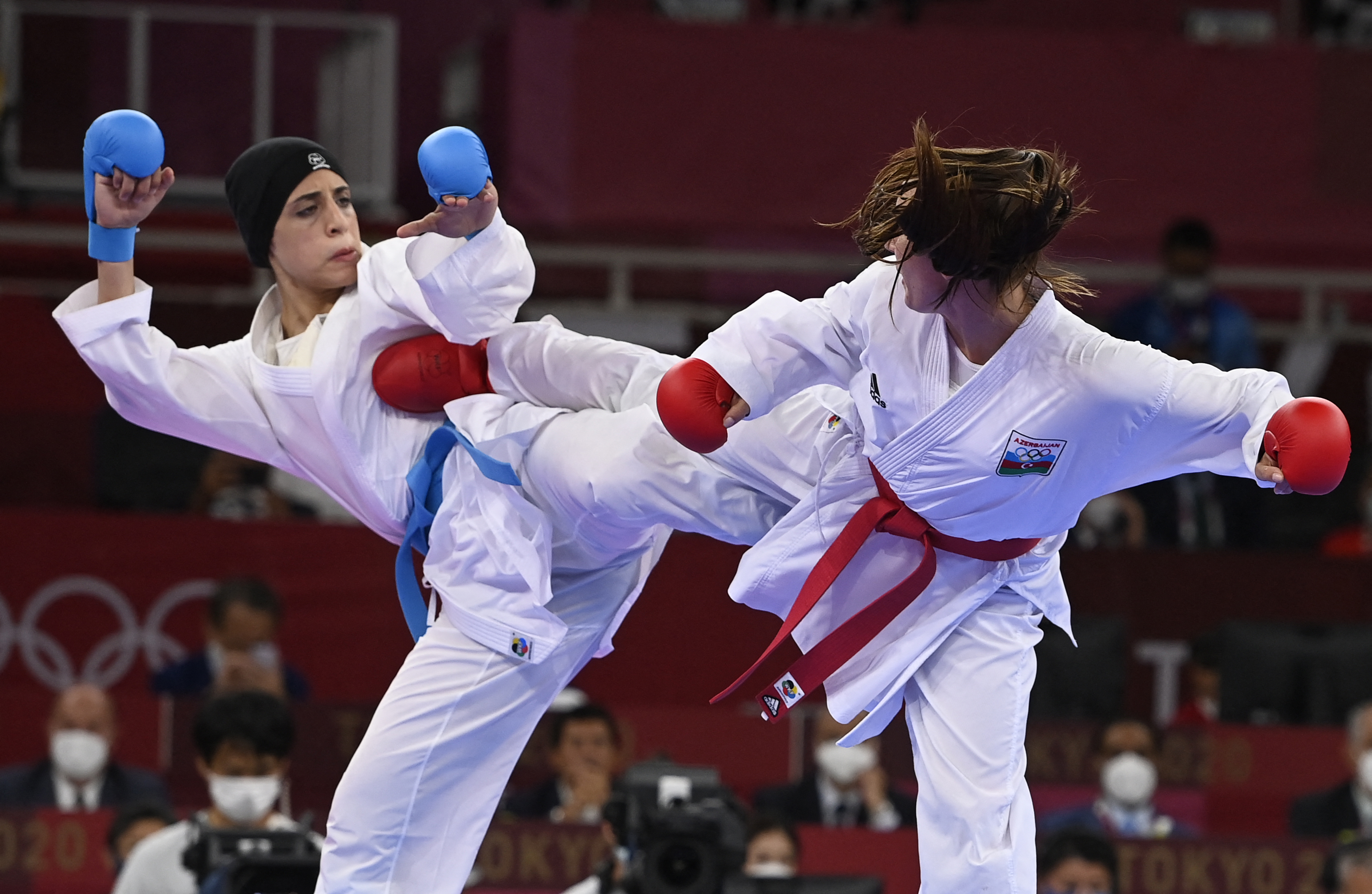 Two karate athletes at the Tokyo 2020 Olympics in mid-fight.