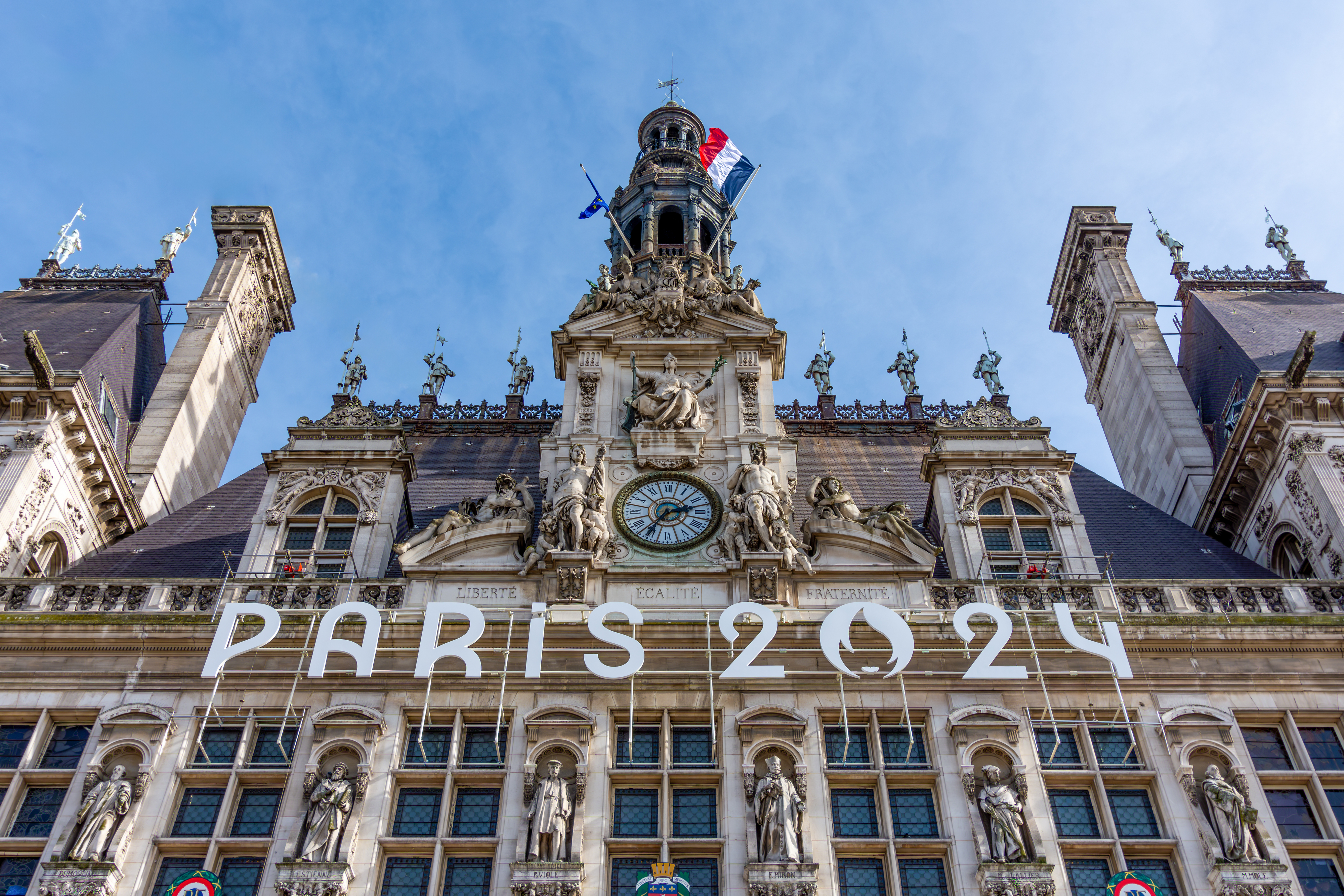Clock tower with a "Paris 2024" sign on it, indicating the countdown to the 2024 Paris Olympics.