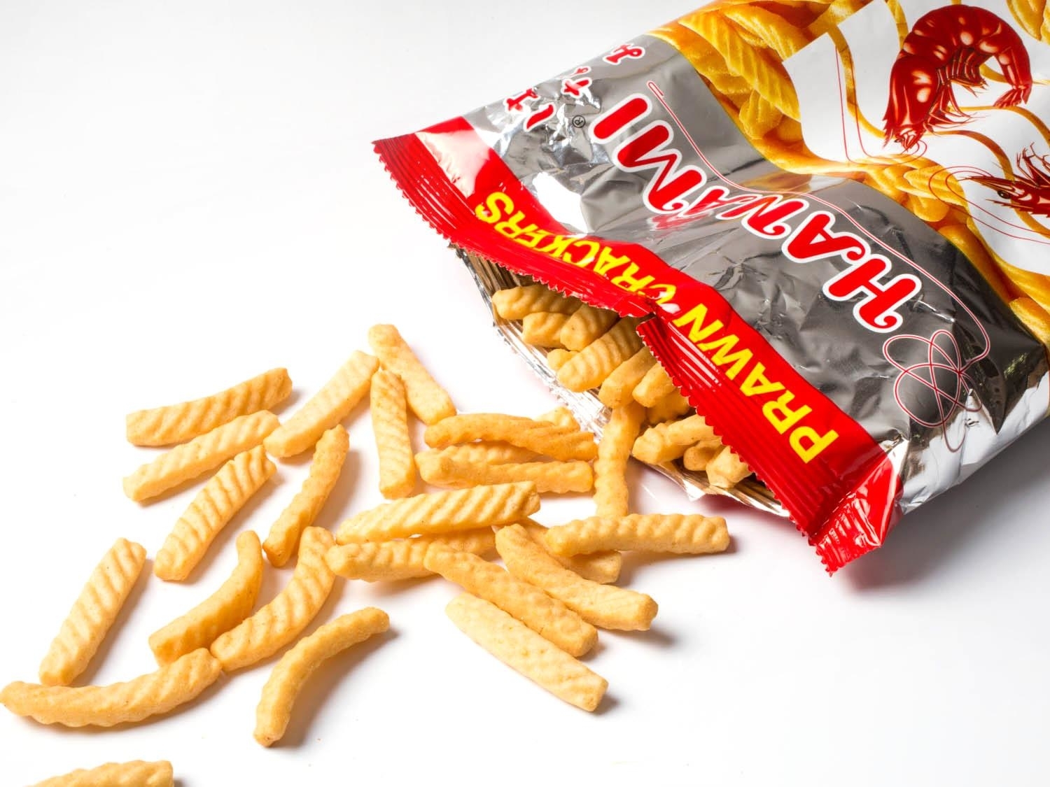 Bag of Hwa Ramyun Pravn French fries chips spills onto a white surface