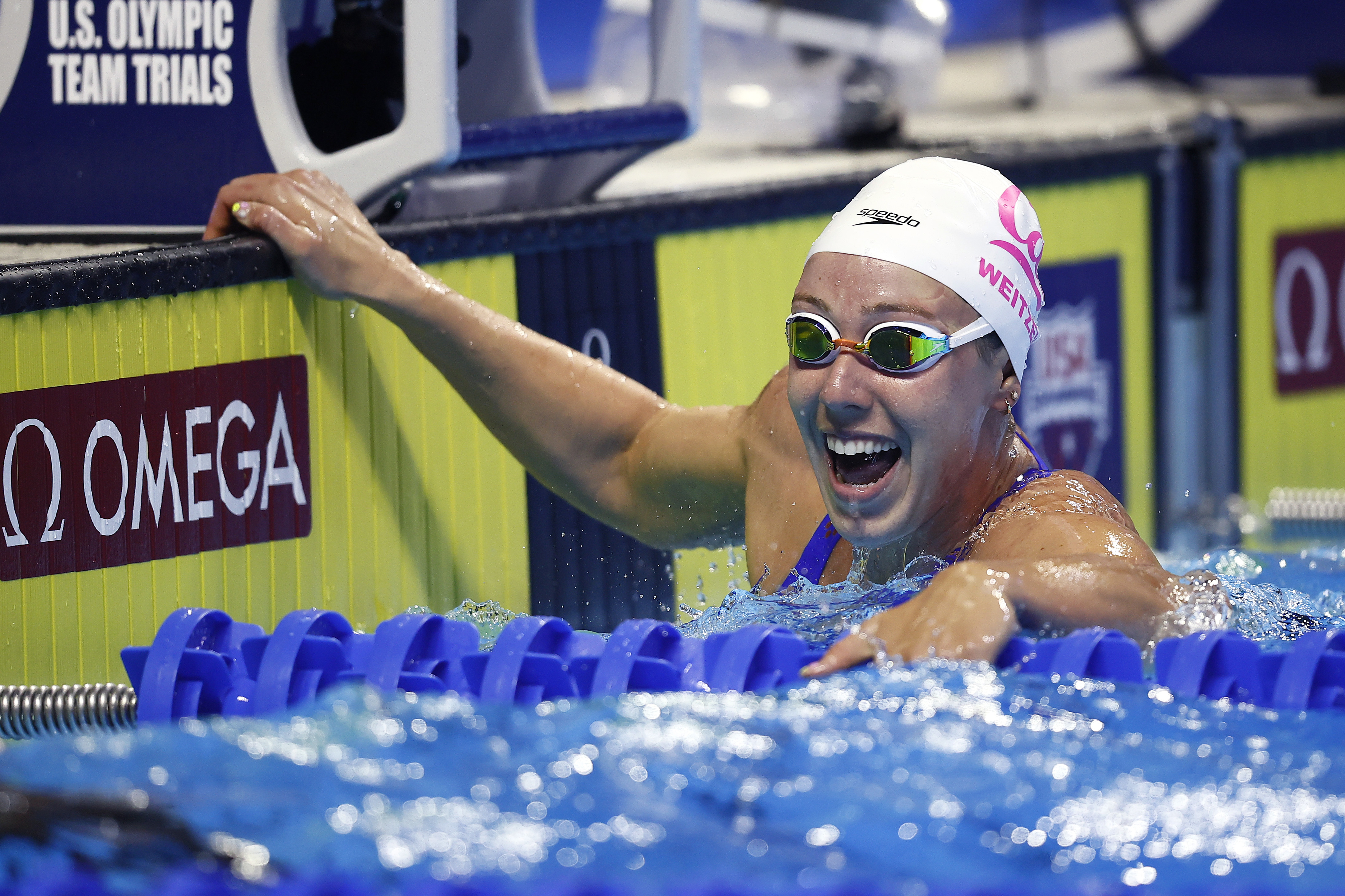 Olympic swimmer Leah Smith joyfully touches the wall after finishing a race during the U.S. Olympic Team Trials