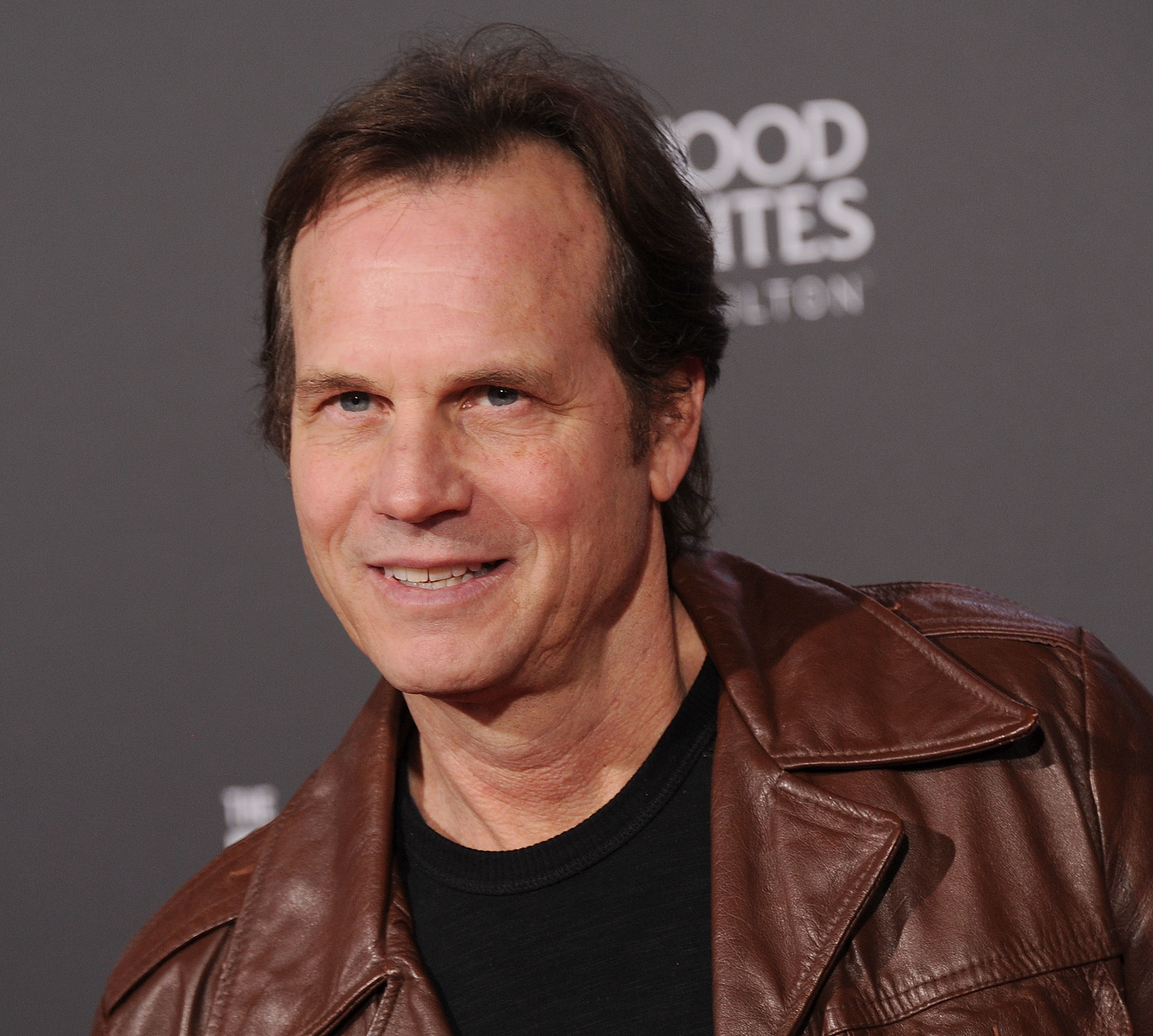 Bill Paxton wearing a casual black shirt and a leather jacket at a public event