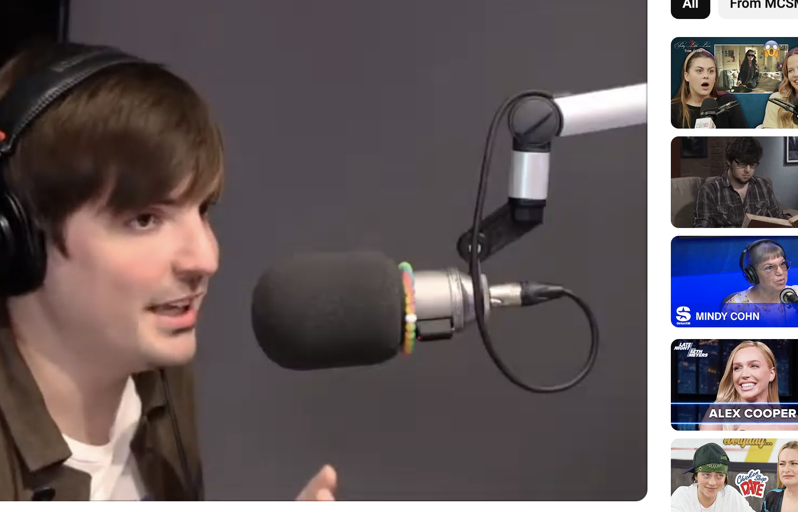 Zach Sang, wearing headphones, speaks into a microphone in a studio during an interview with Sabrina Carpenter for a YouTube video titled &quot;Awkward Sabrina Carpenter interview with Zach Sang.&quot;