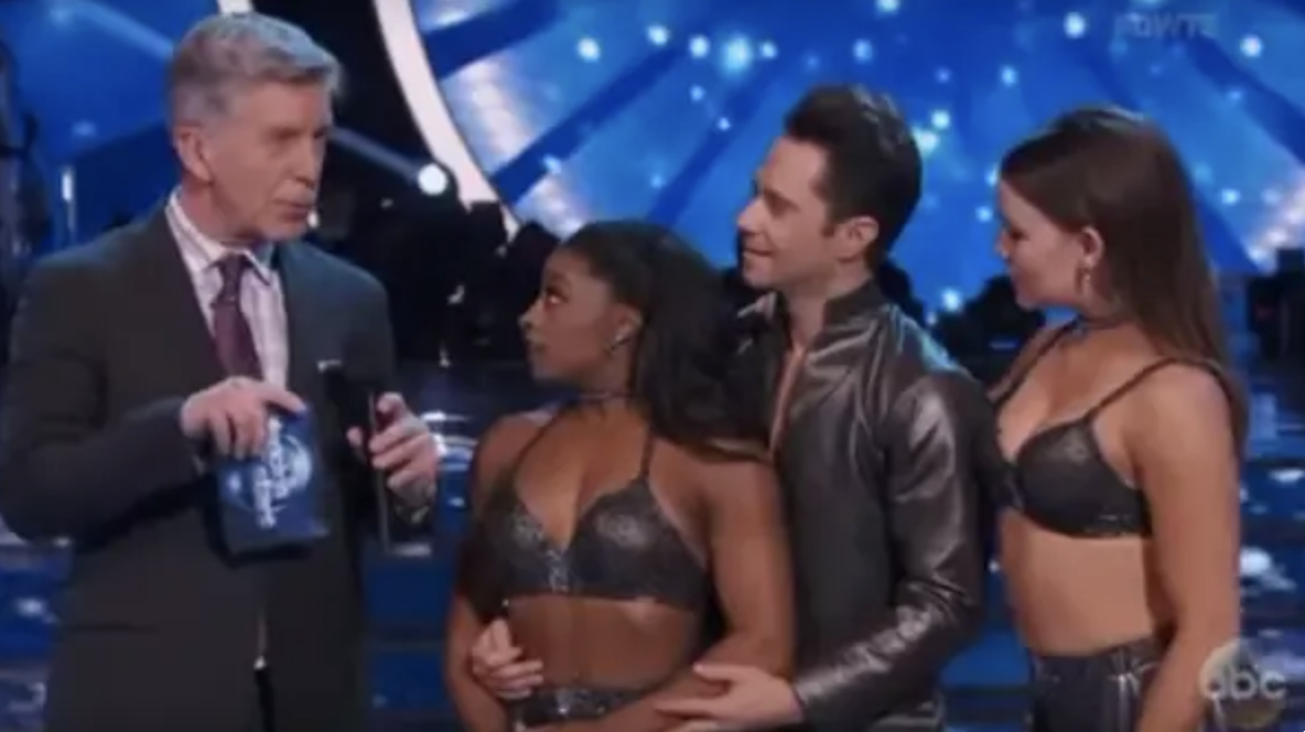 Tom Bergeron interviews Simone Biles, Sasha Farber, and a third unidentified woman, discussing a dance performance