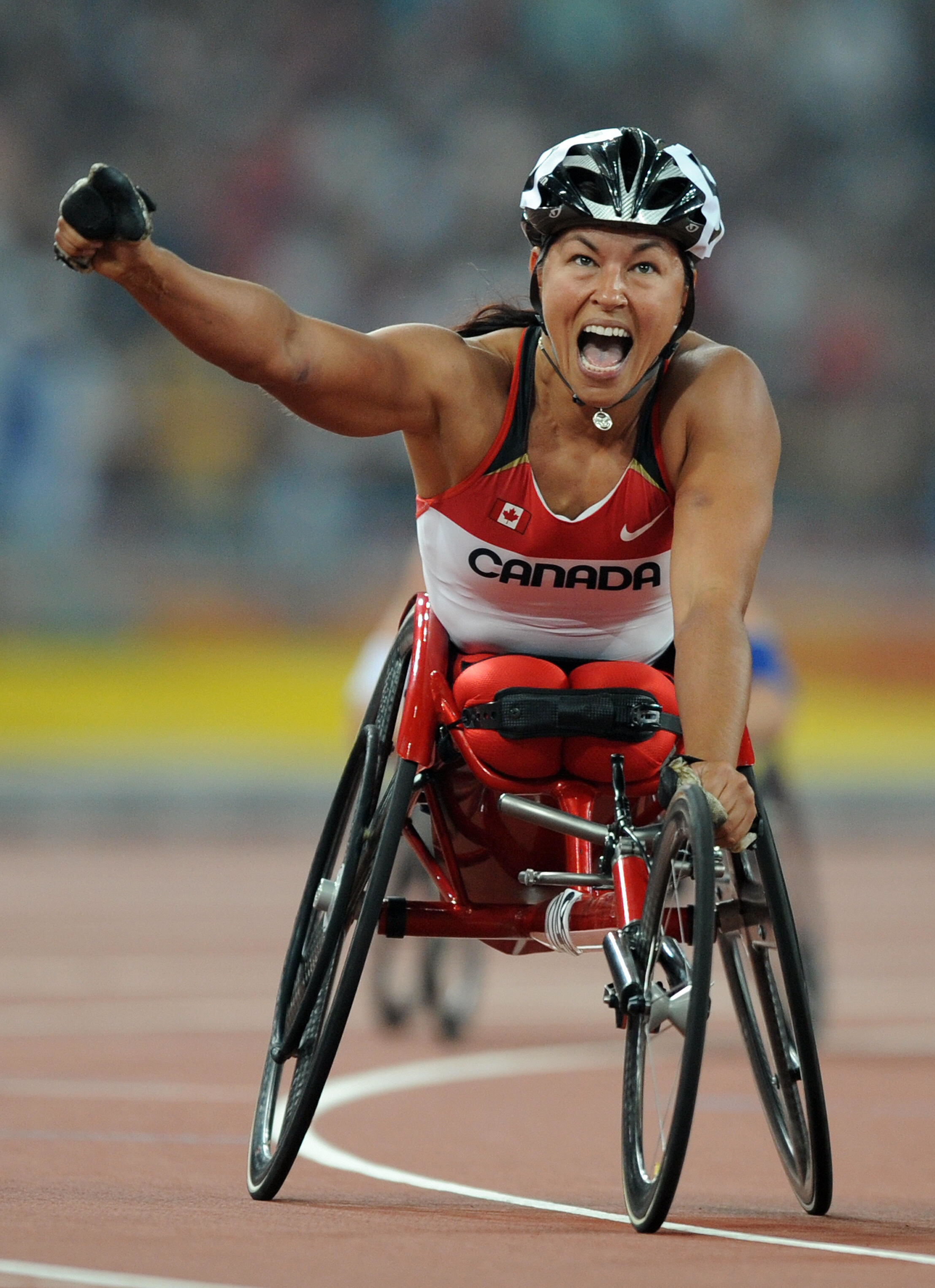 Canadian Paralympic athlete Michelle Stilwell celebrates in her racing wheelchair during a competition